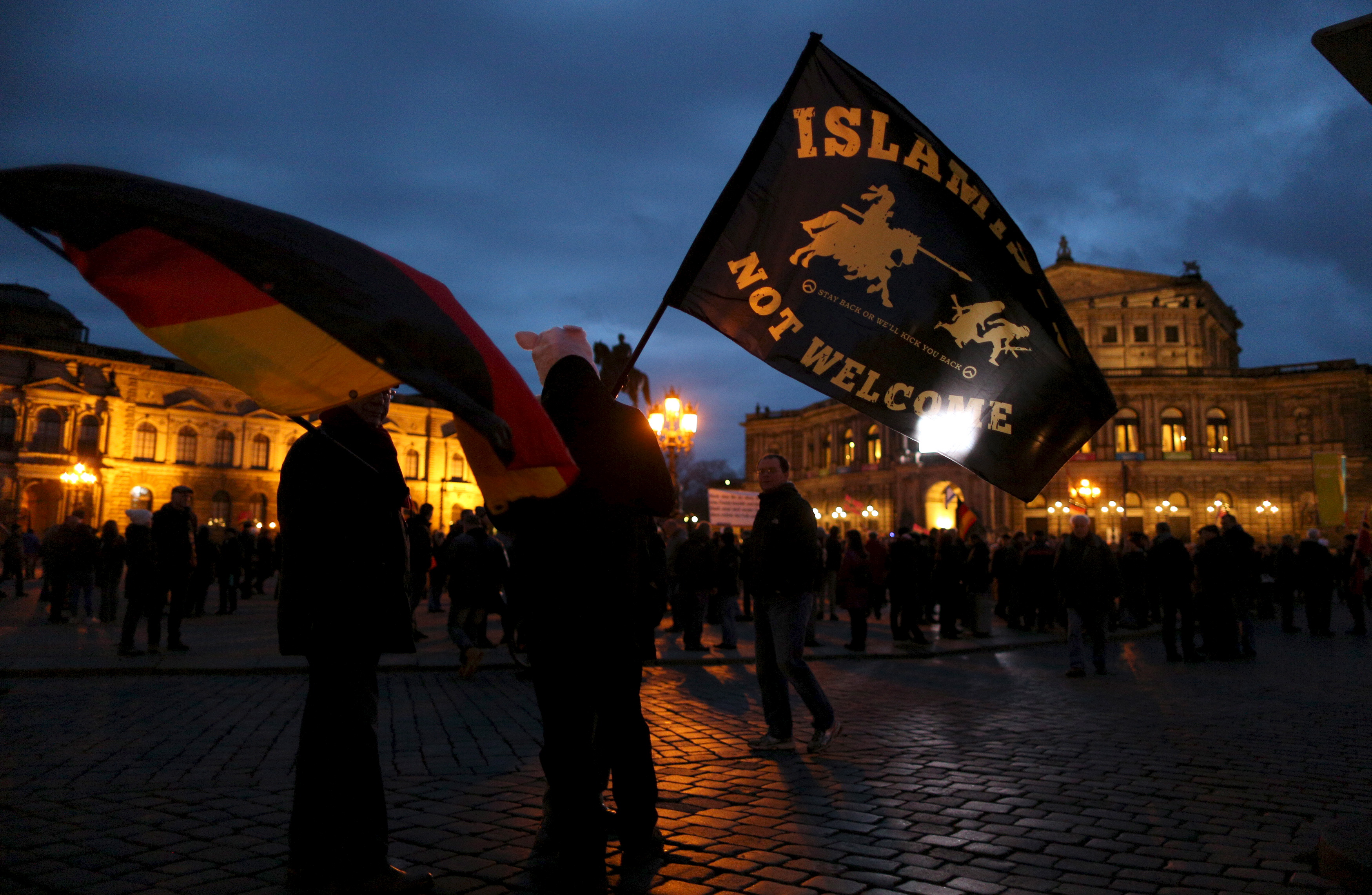 Supporters of the anti-Islam movement "Patriotic Europeans Against the Islamisation of the West" (PEGIDA) wave flags during a demonstration in Dresden, Germany, March 21, 2016. REUTERS/Ina Fassbender