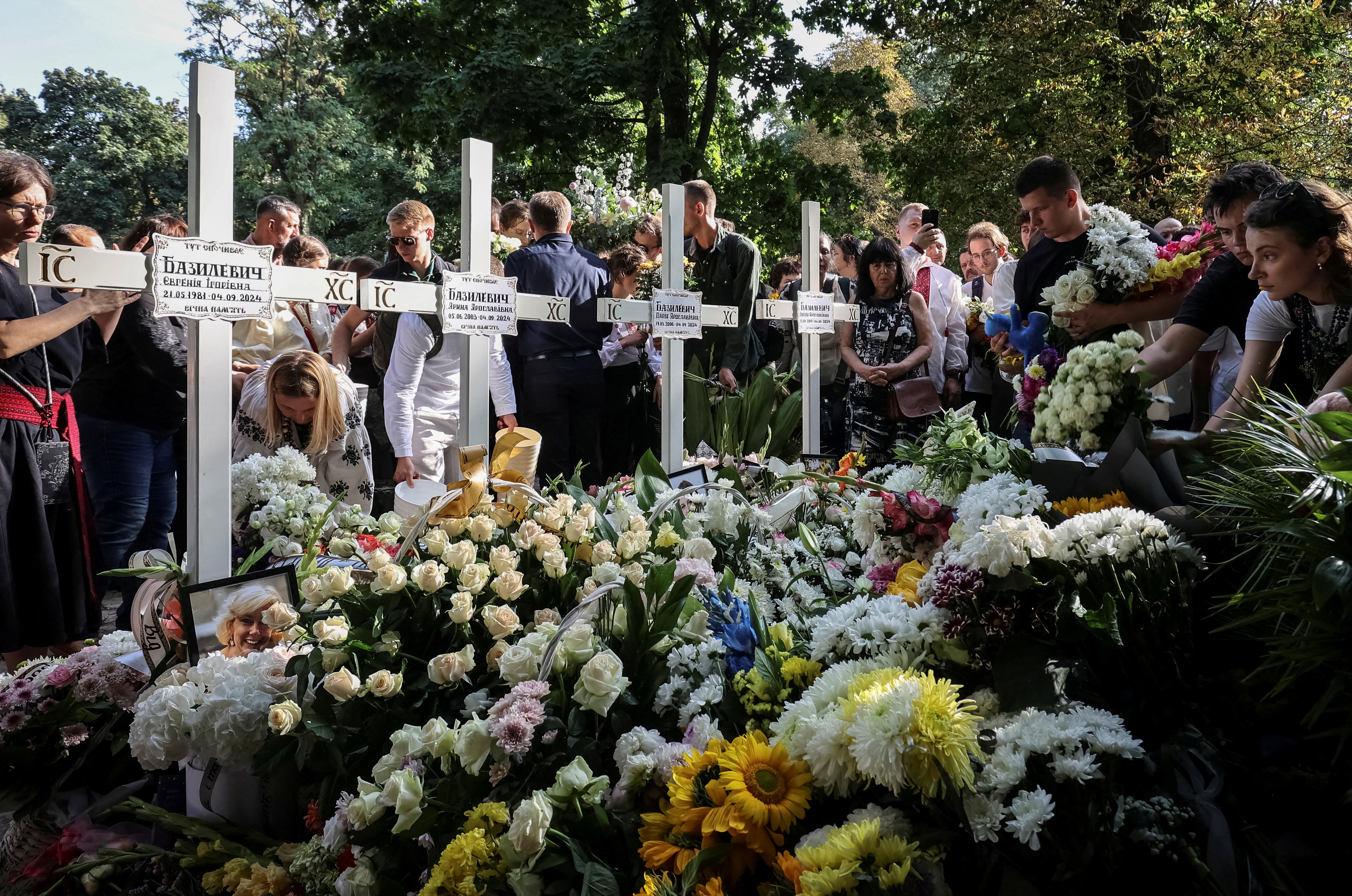 People attend a funeral ceremony for Yevhenia Bazylevych and her three daughters, killed during the Russian missile attack on September 4 as Yaroslav her husband, was the only survivor out of the entire family, amid Russia's attack on Ukraine, in Lviv, Ukraine September 6, 2024. REUTERS/Roman Baluk TPX IMAGES OF THE DAY