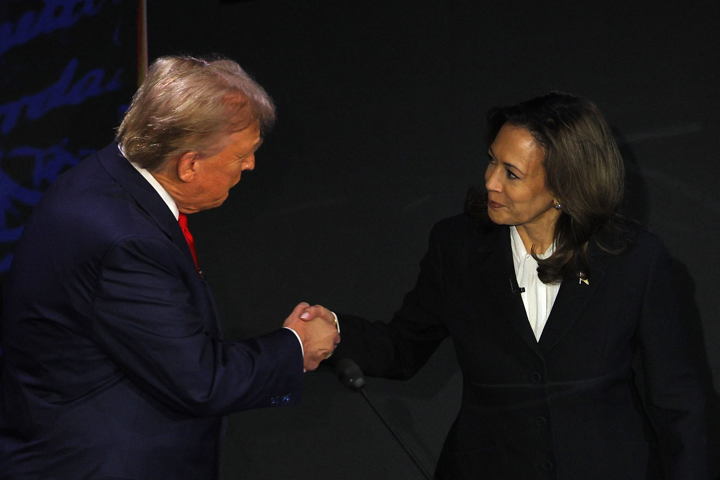Harris and Trump shake hands.