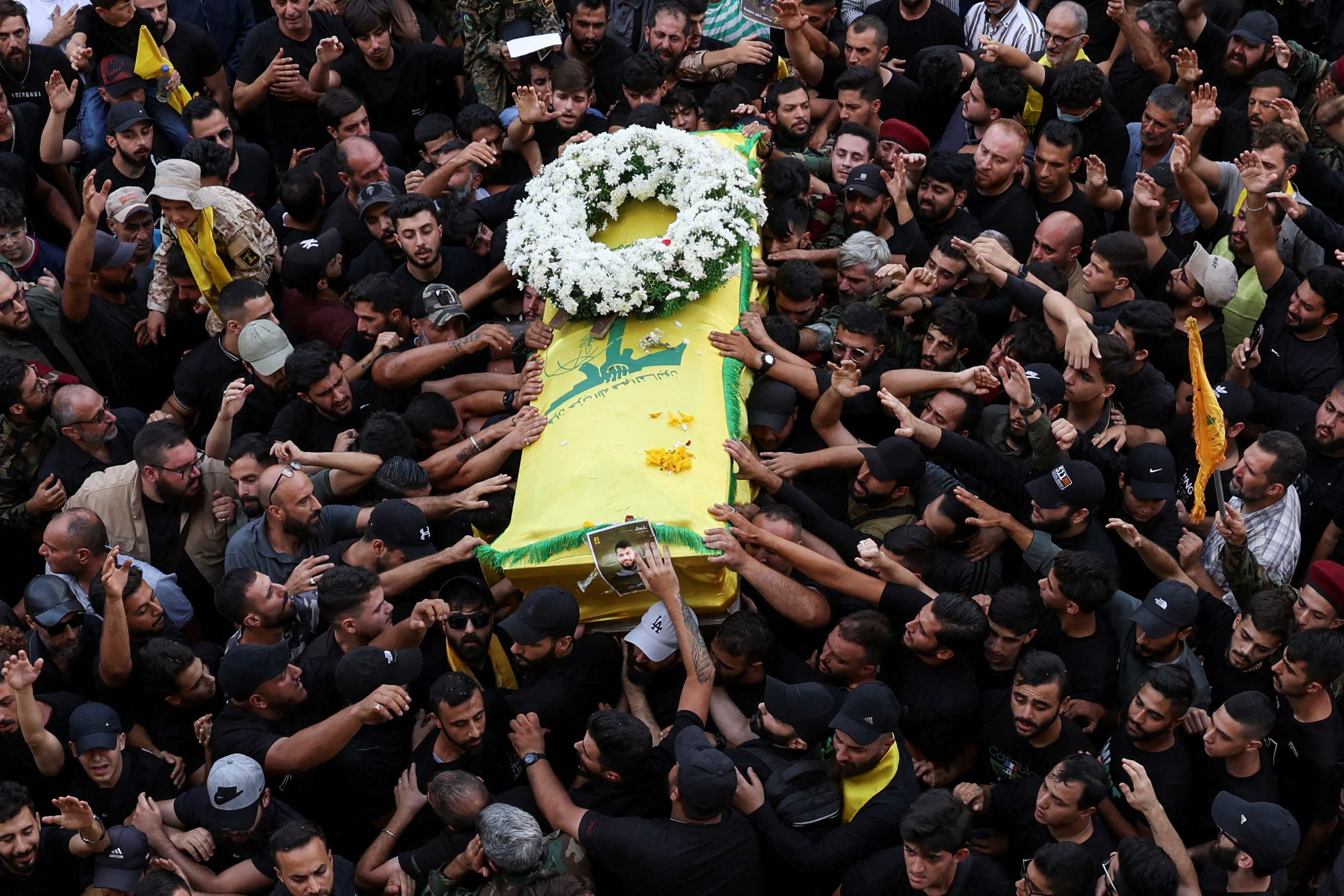 Mourners gather at the funeral of Hezbollah members Fadel Abbas Bazzi and Ahmad Ali Hassan,
