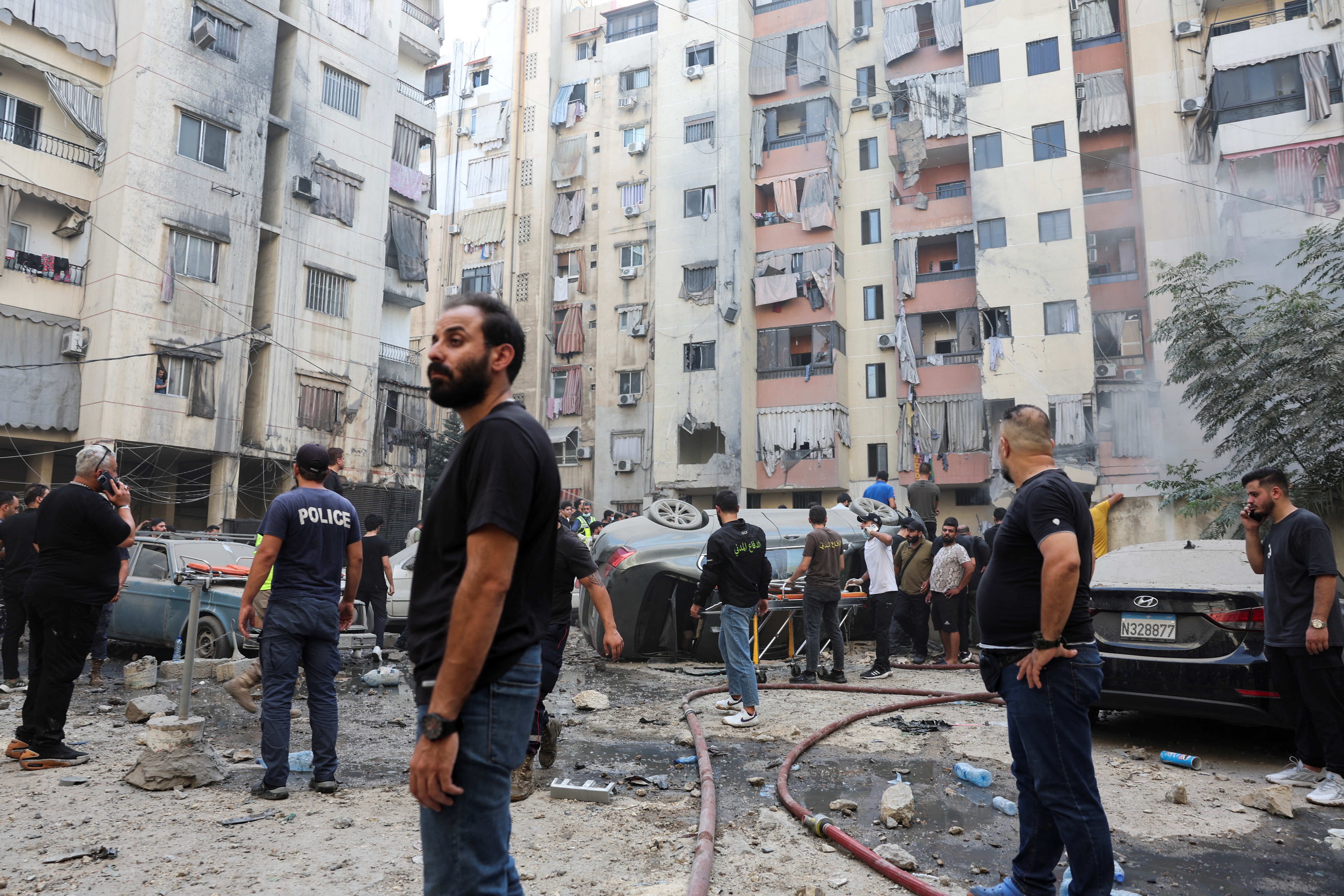 People inspect the site of an Israeli strike in the southern suburbs of Beirut