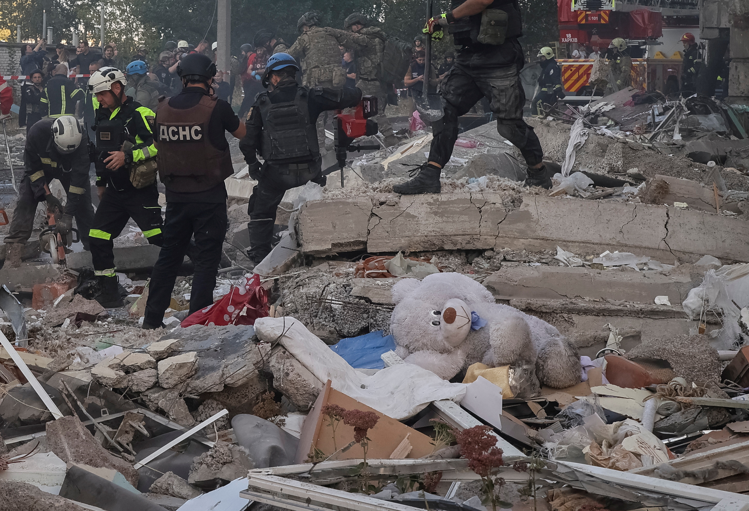 Rescuers work at the site of an apartment building hit by a Russian air strike on Kharkiv, Ukraine