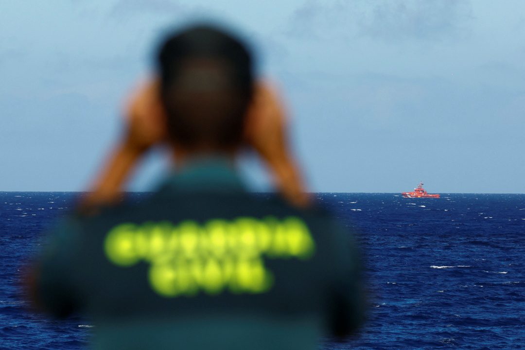 A Civil Guard officer watches a rescue boat in El Hierro