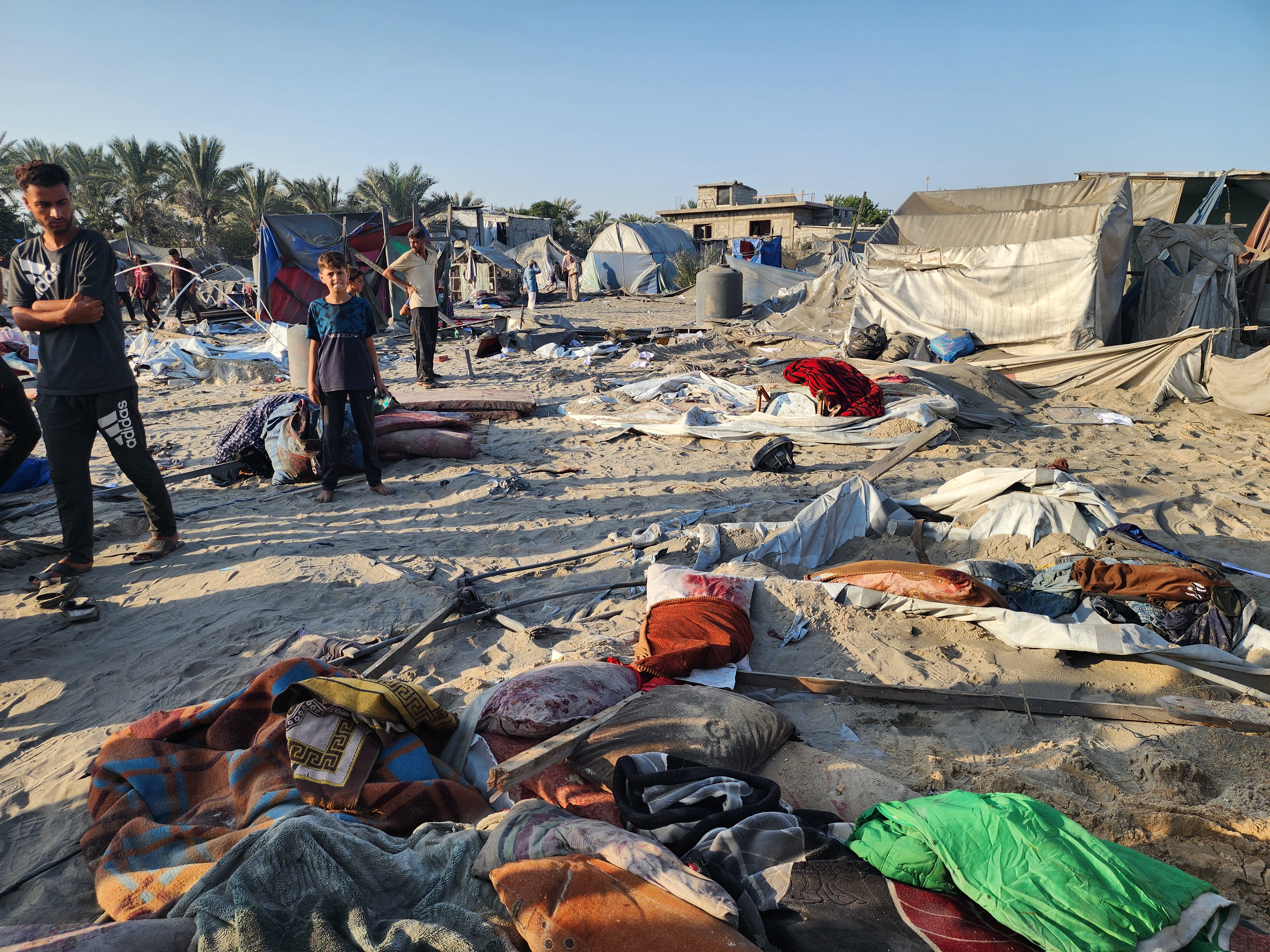 Israel strikes a tent encampment of displaced Palestinians in Al-Mawasi [Mohammed Salem/Reuters]