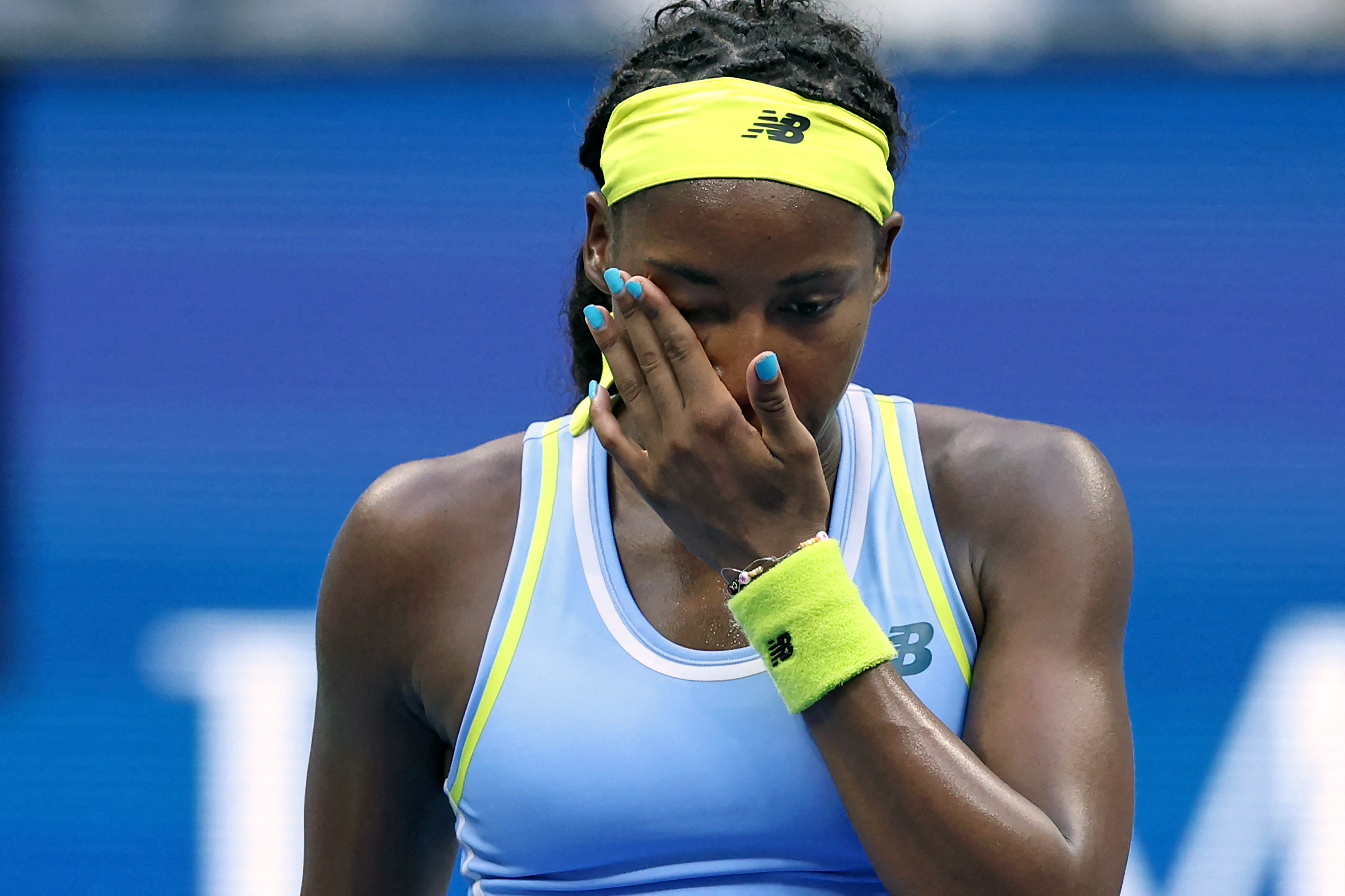 USA's Coco Gauff wipes her face after losing her women's singles round of 16 tennis match against USA's Emma Navarro on day seven of the US Open tennis tournament at the USTA Billie Jean King National Tennis Center in New York City, on September 1, 2024. (Photo by CHARLY TRIBALLEAU / AFP)
