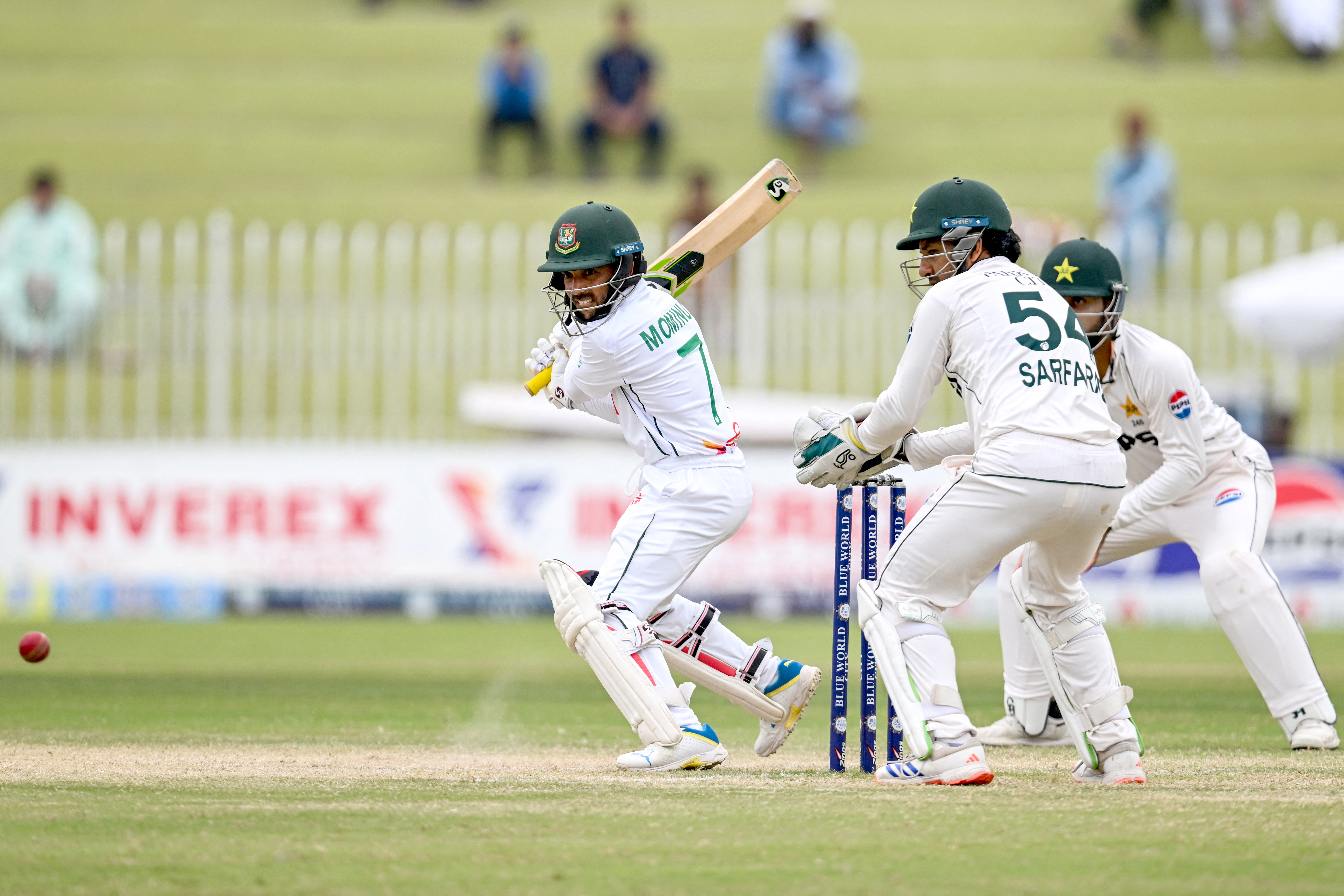 Bangladesh's Mominul Haque (L) plays a shot during the fifth and final day of the second and last Test cricket match between Pakistan and Bangladesh, at the Rawalpindi Cricket Stadium in Rawalpindi on September 3, 2024. (Photo by Aamir QURESHI / AFP)