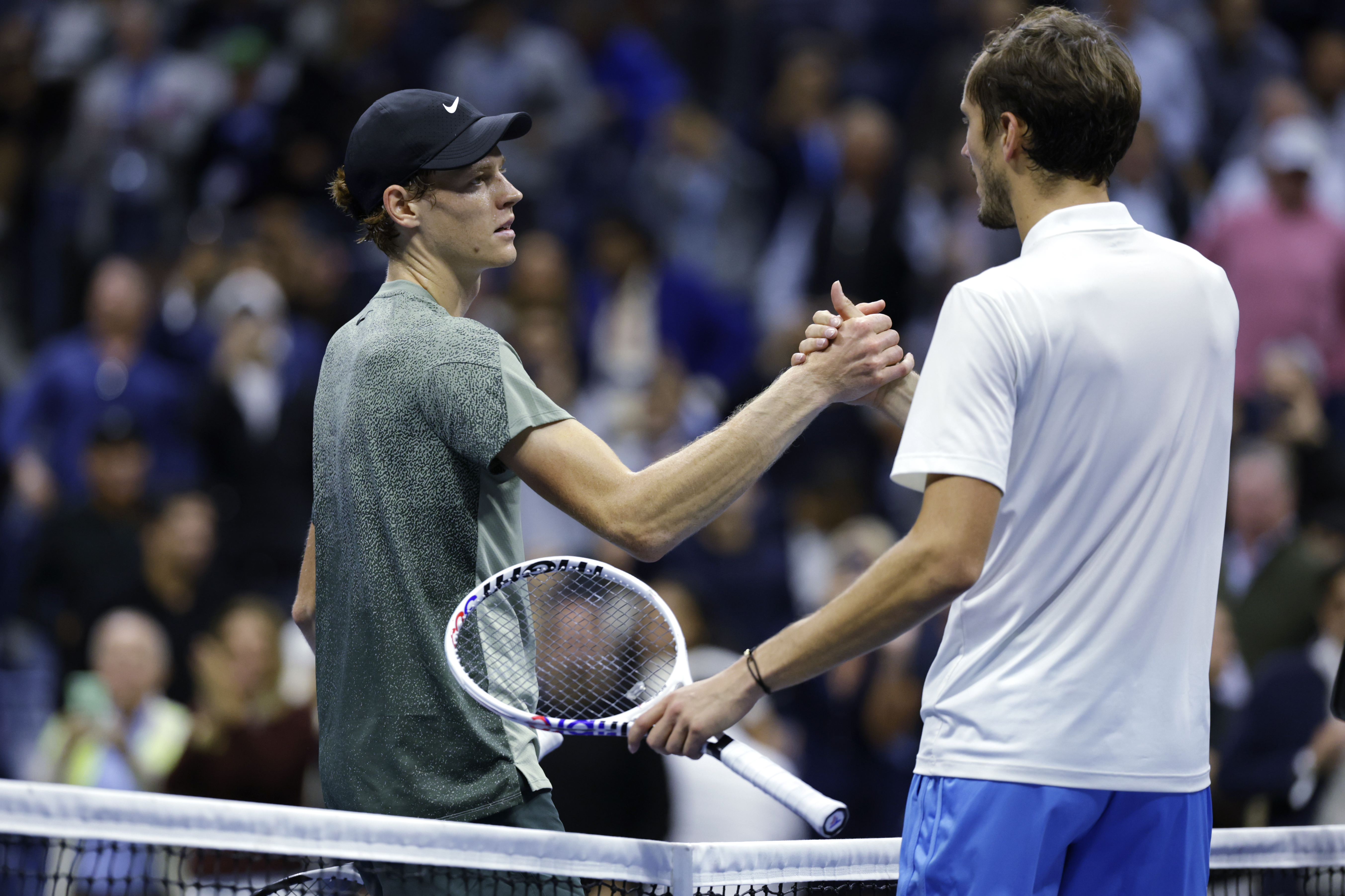 Jannik Sinner, of Italy, left, shakes hands after defeating Daniil Medvedev, of Russia, during the quarterfinals of the U.S. Open tennis championships, Wednesday, Sept. 4, 2024, in New York. (AP Photo/Adam Hunger)