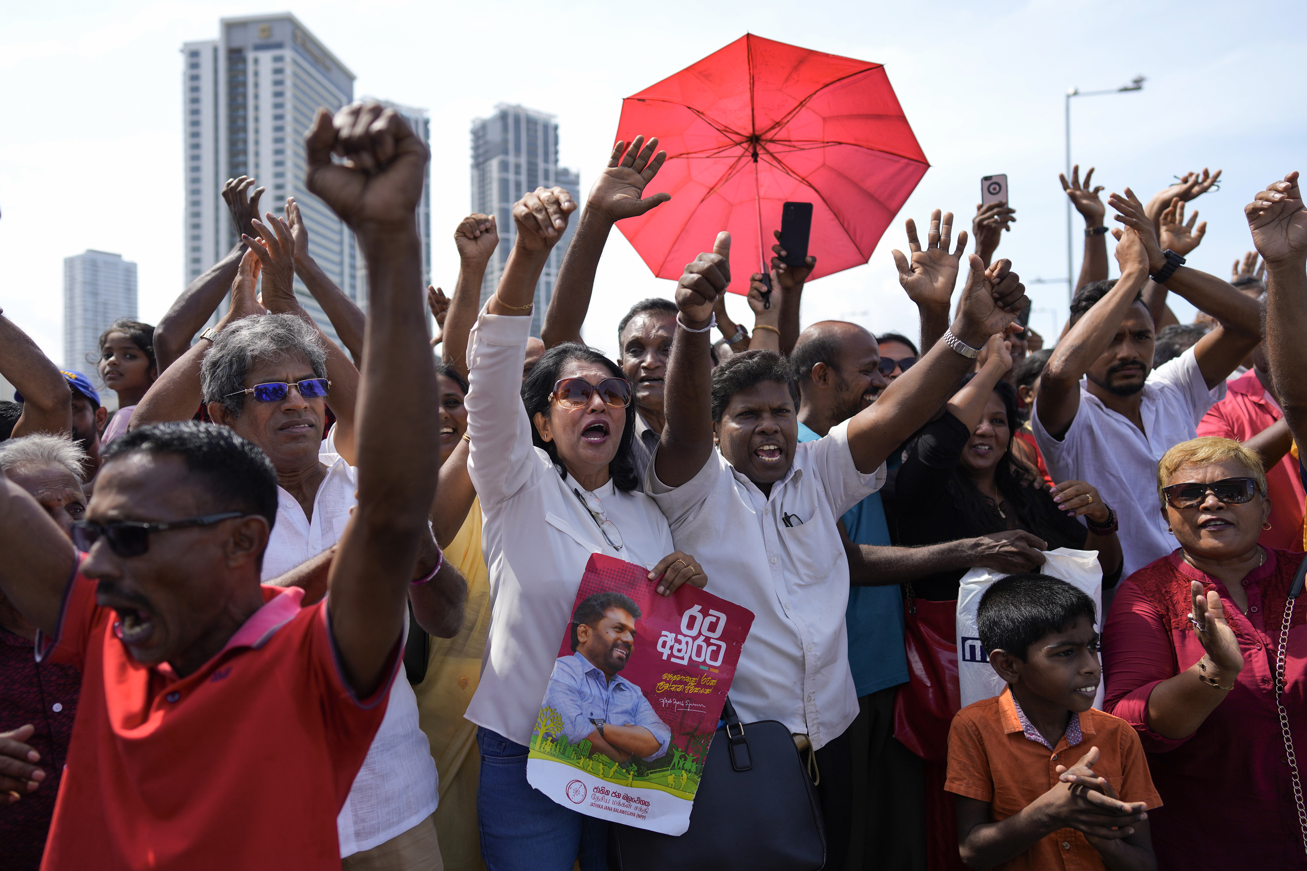 Supporters of Marxist-leaning Anura Kumara Dissanayake cheer outside the president's office as he arrives to be sworn in as Sri Lanka&rsquo;s president in Colombo [File: Eranga Jayawardena/AP Photo]