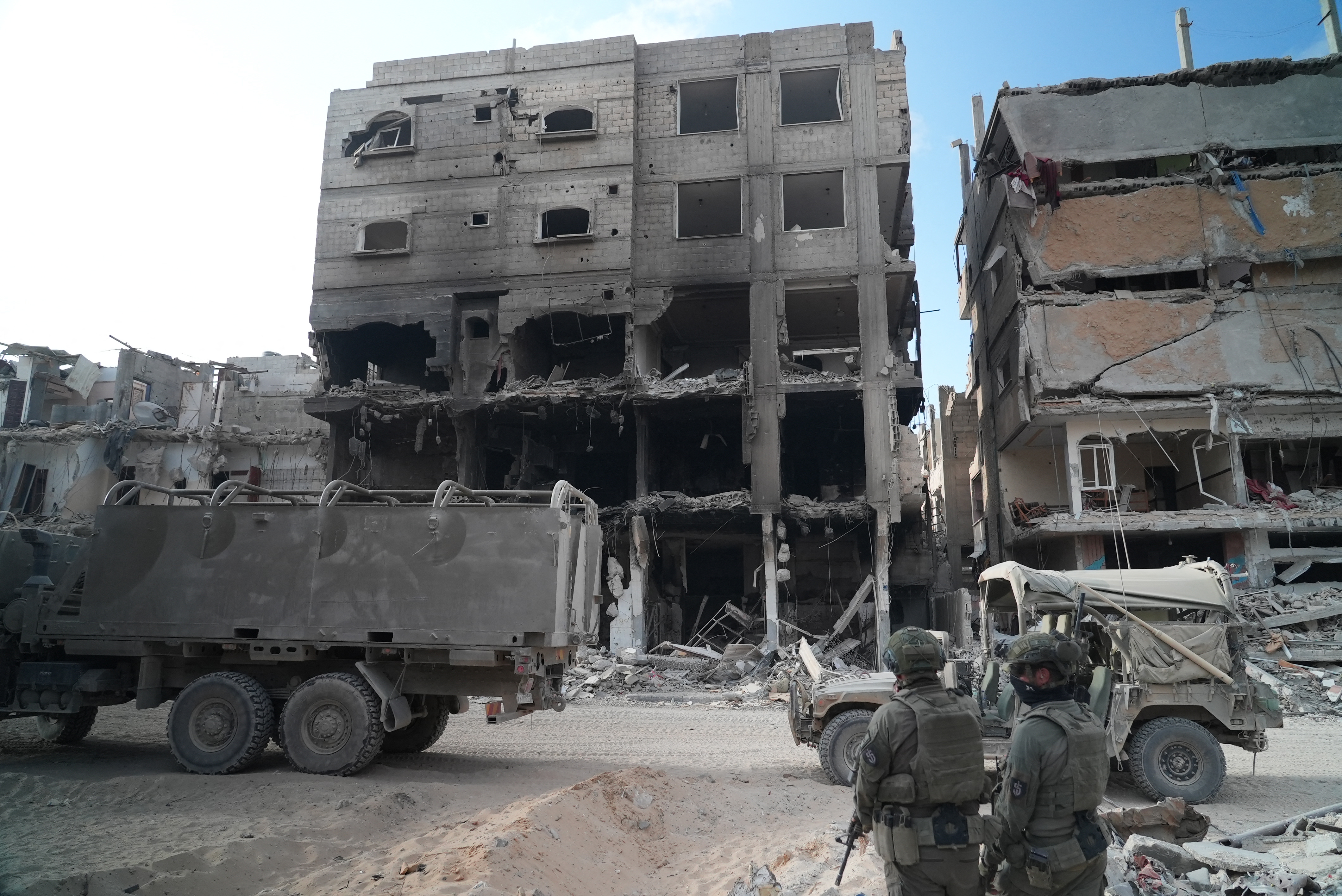 Israeli soldiers patrol next to destroyed buildings in Rafah, southern Gaza, on Friday [Sharon Aronowicz/AFP]