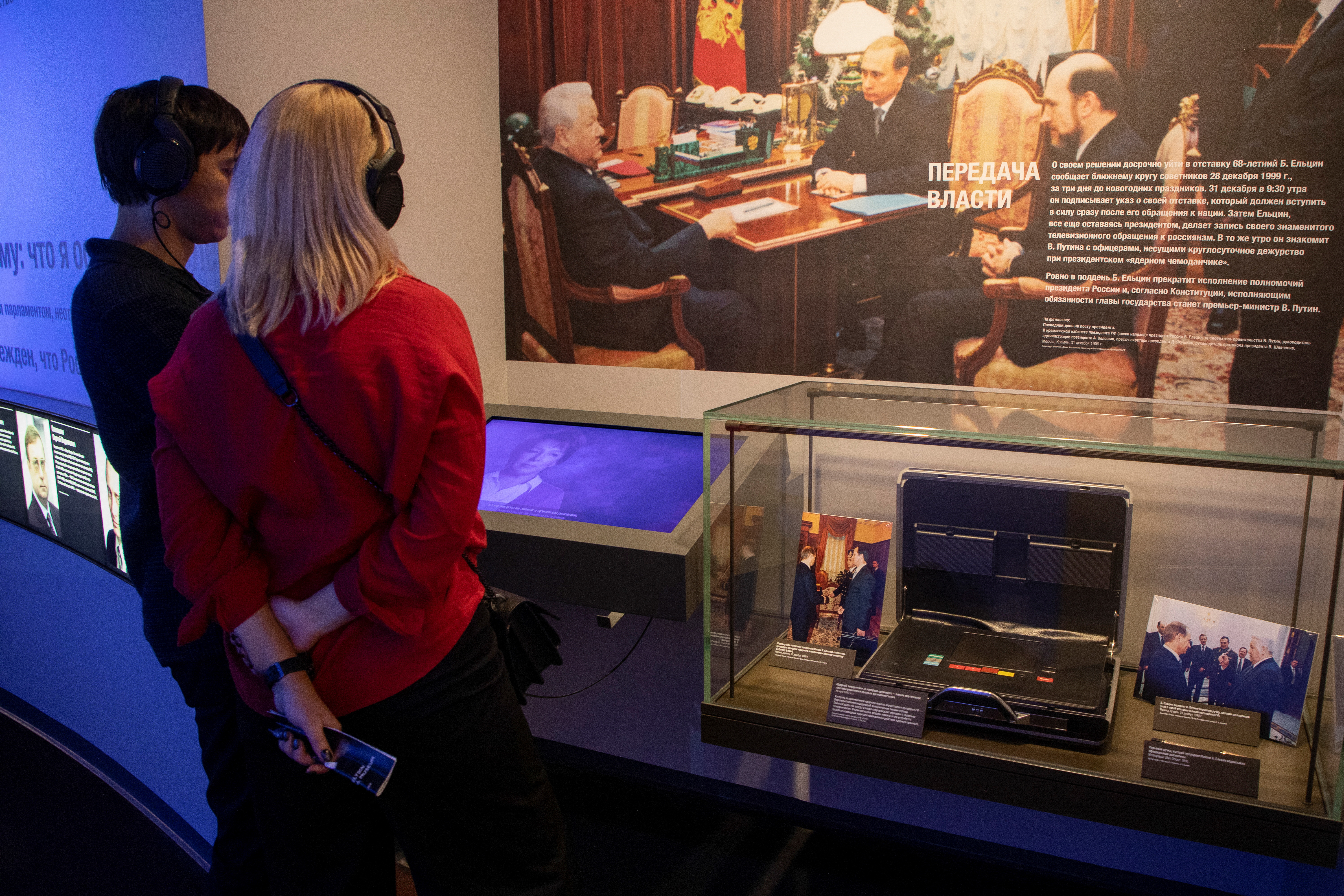 Photographs showing officials, including Russia's incumbent president Vladimir Putin, are on display next to the so-called Russia's nuclear briefcase also known as the "Cheget", which was in use during Russian first President Boris Yeltsin's years in office and could authenticate an order to launch nuclear missiles, at the exposition of the Boris Yeltsin Presidential Centre in Yekaterinburg, Russia, October 18, 2022. REUTERS/Natalia Chernokhatova
