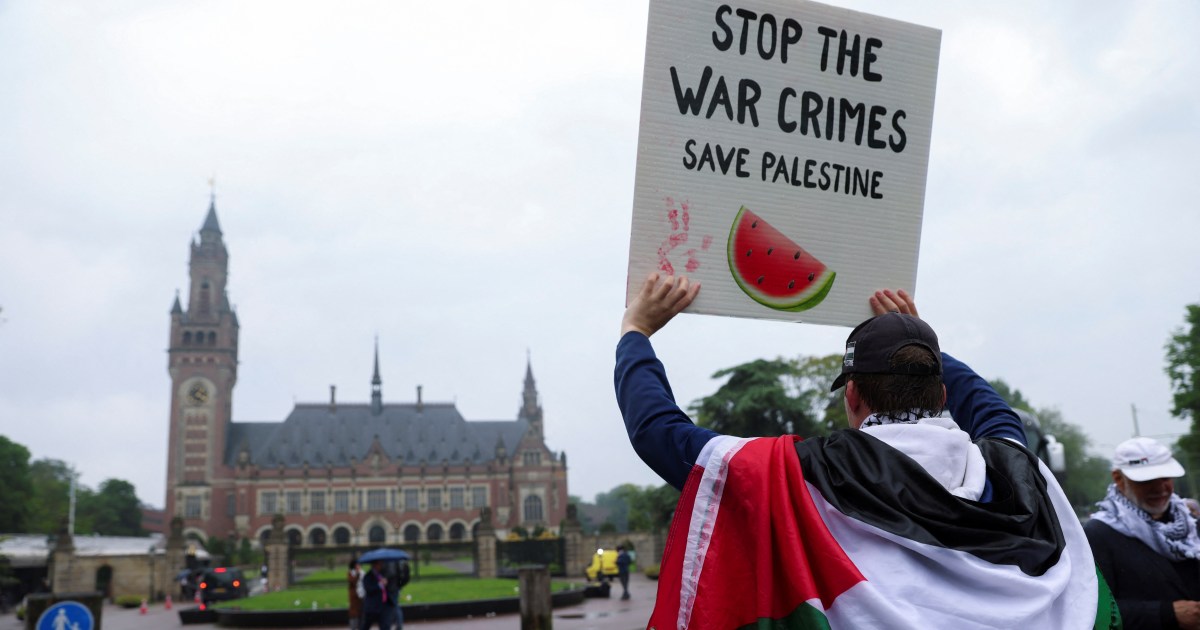 Outside the International Court of Justice, a protester draped in a Palestinian flag calls for an end to Israel's war on Gaza [File: Johanna Geron/Reuters]