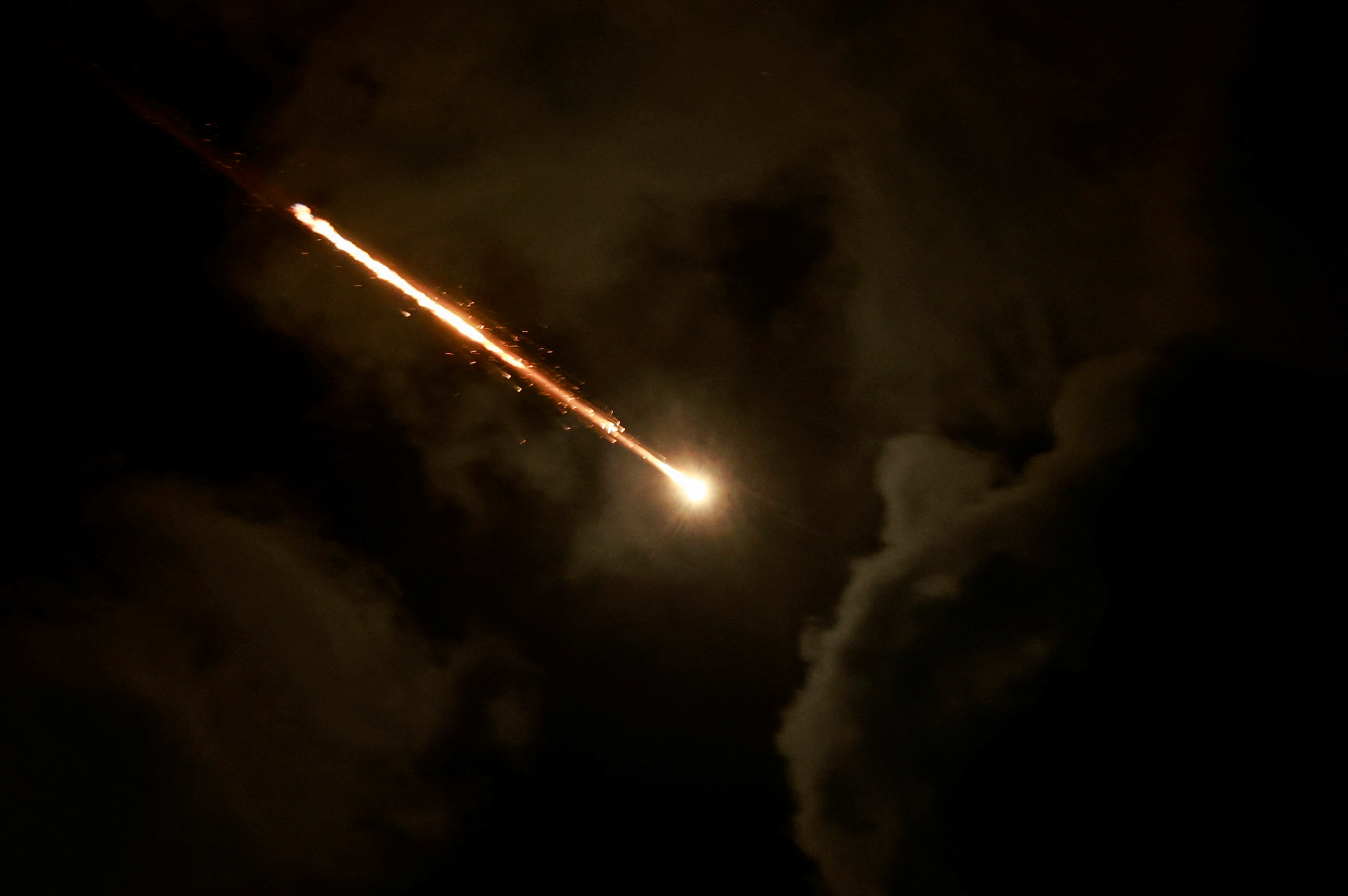 A projectile is seen in the sky after Iran fired a salvo of ballistic missiles, amid cross-border hostilities between Hezbollah and Israel, as seen from Tel Aviv, Israel, October 1, 2024. [Ammar Awad/Reuters]