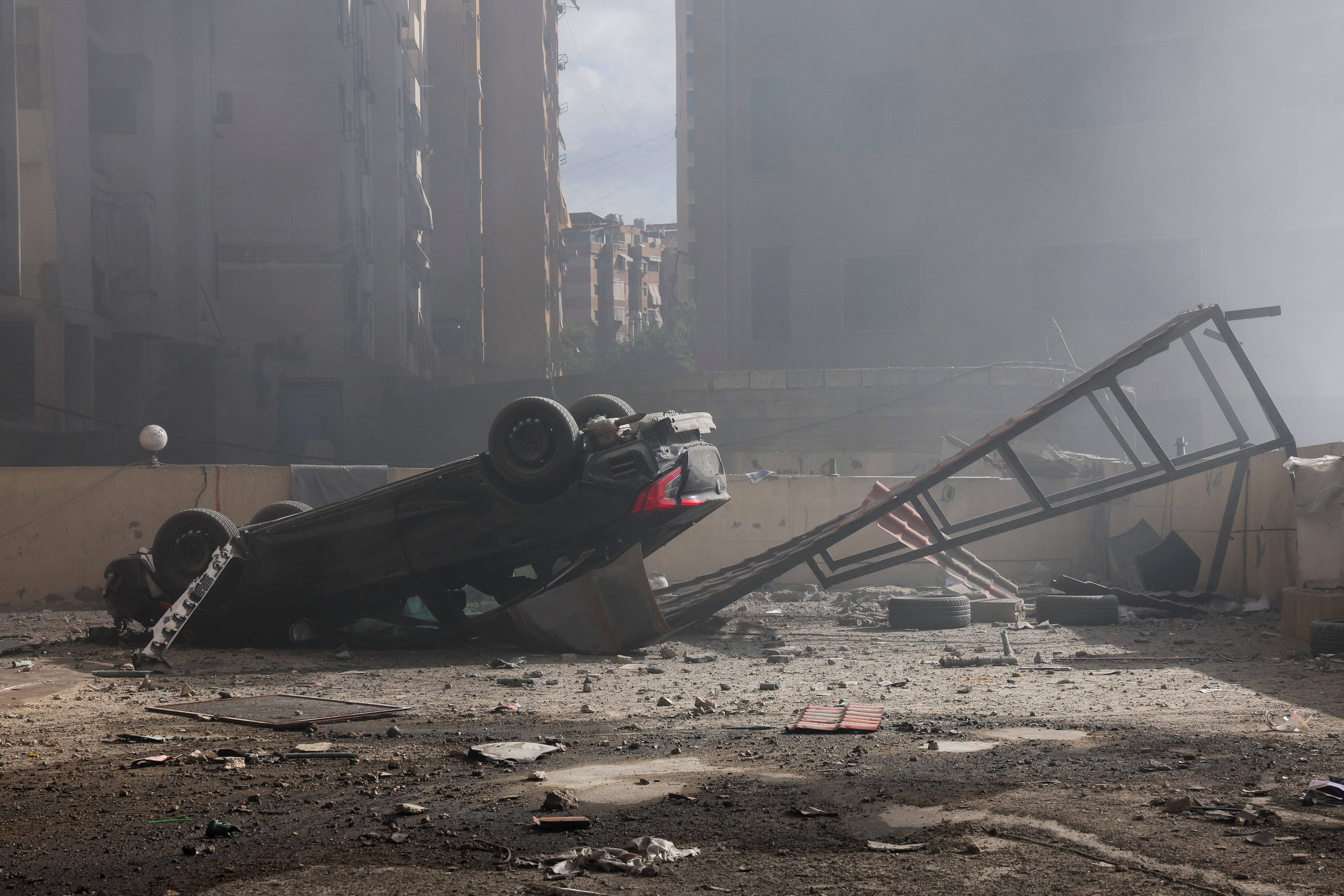 A destroyed vehicle is seen among rubble in the aftermath of Israeli strikes in Chiyah