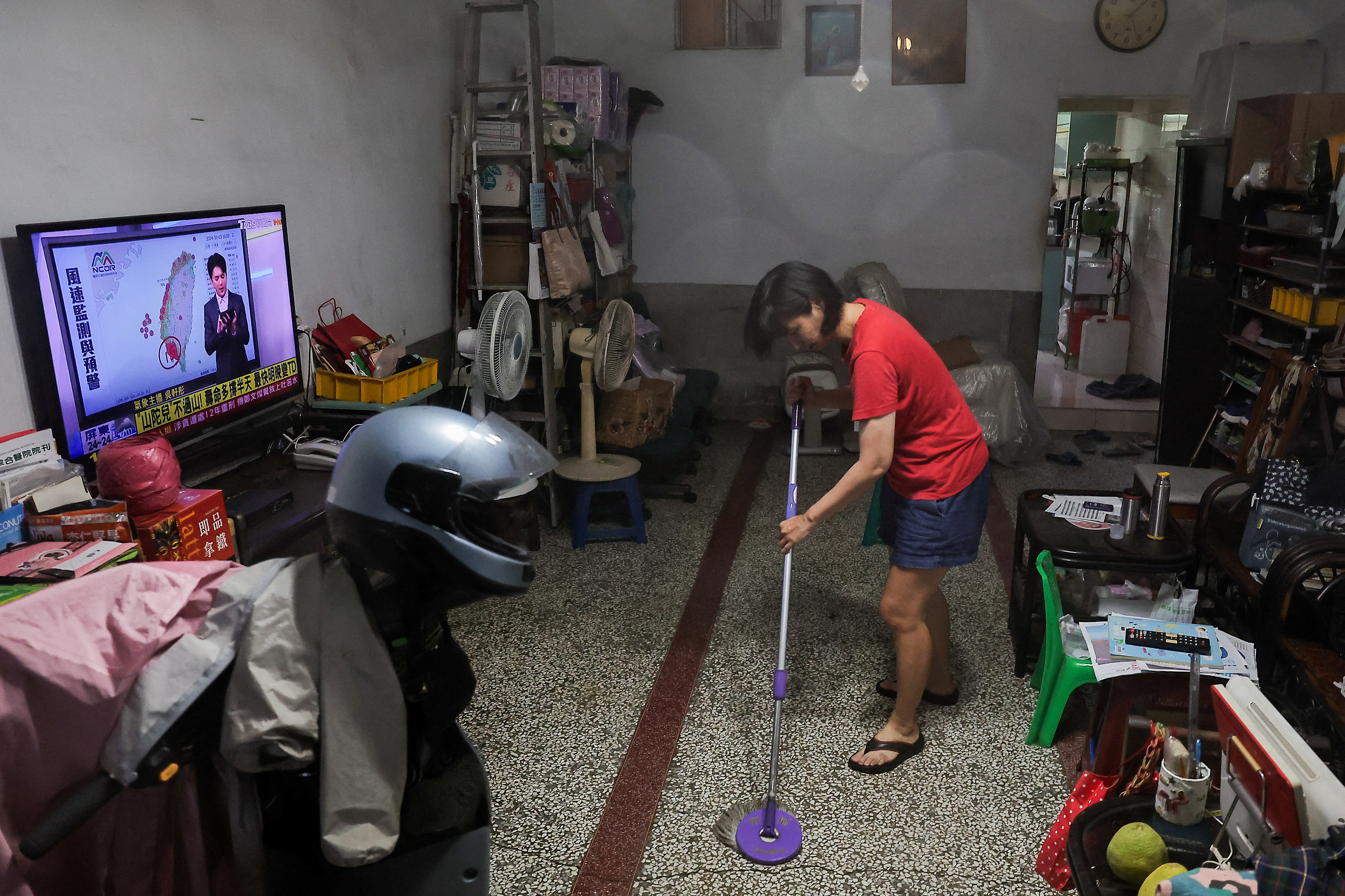 People clean their house from flood after Typhoon Krathon made landfall in Kaohsiung, Taiwan October 3