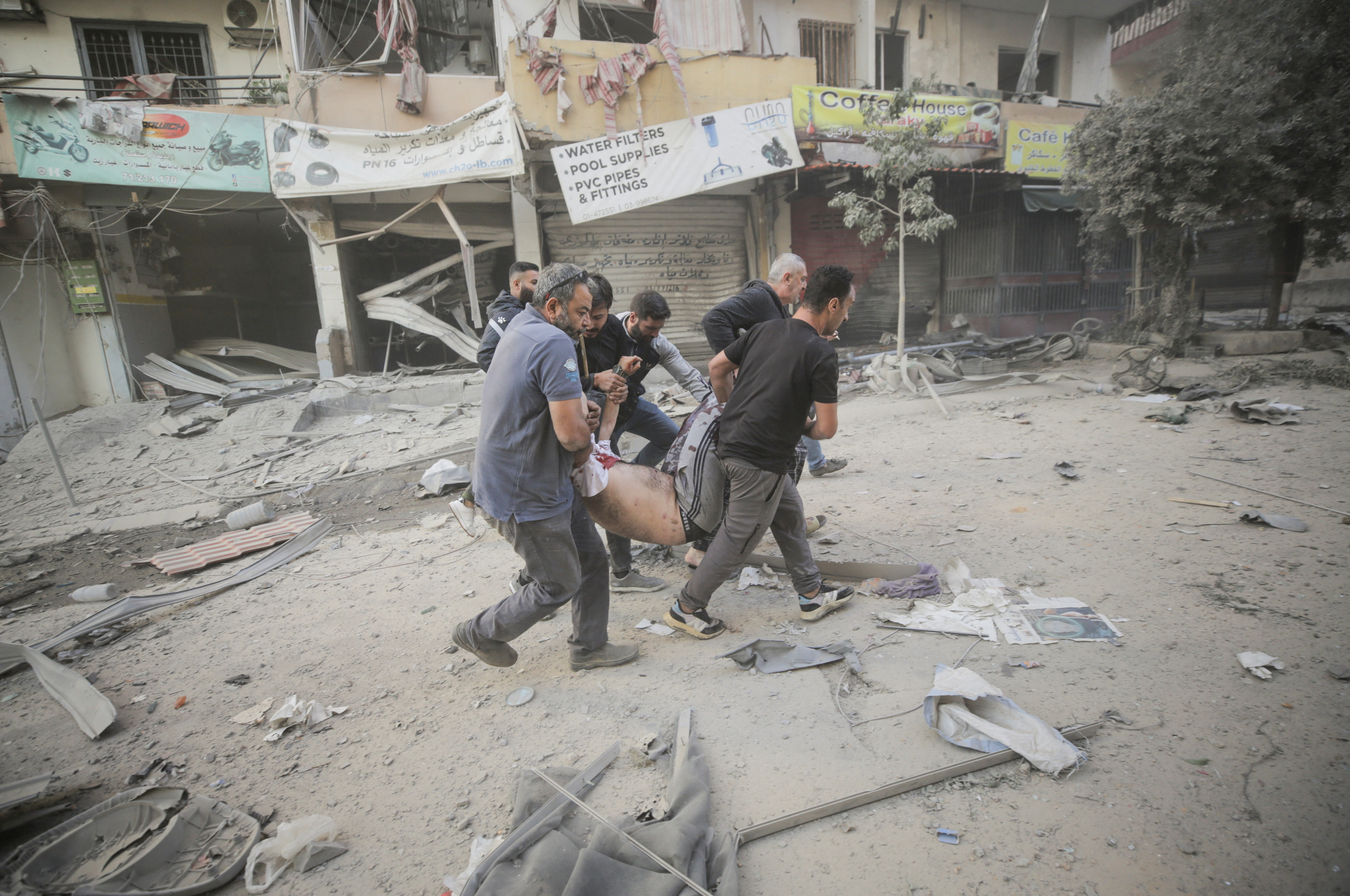 People carry a wounded man, after an Israeli strike on the Mreijeh neighbourhood in Beirut's southern suburbs, amid cross-border hostilities between Hezbollah and Israel, in Beirut, Lebanon October 4