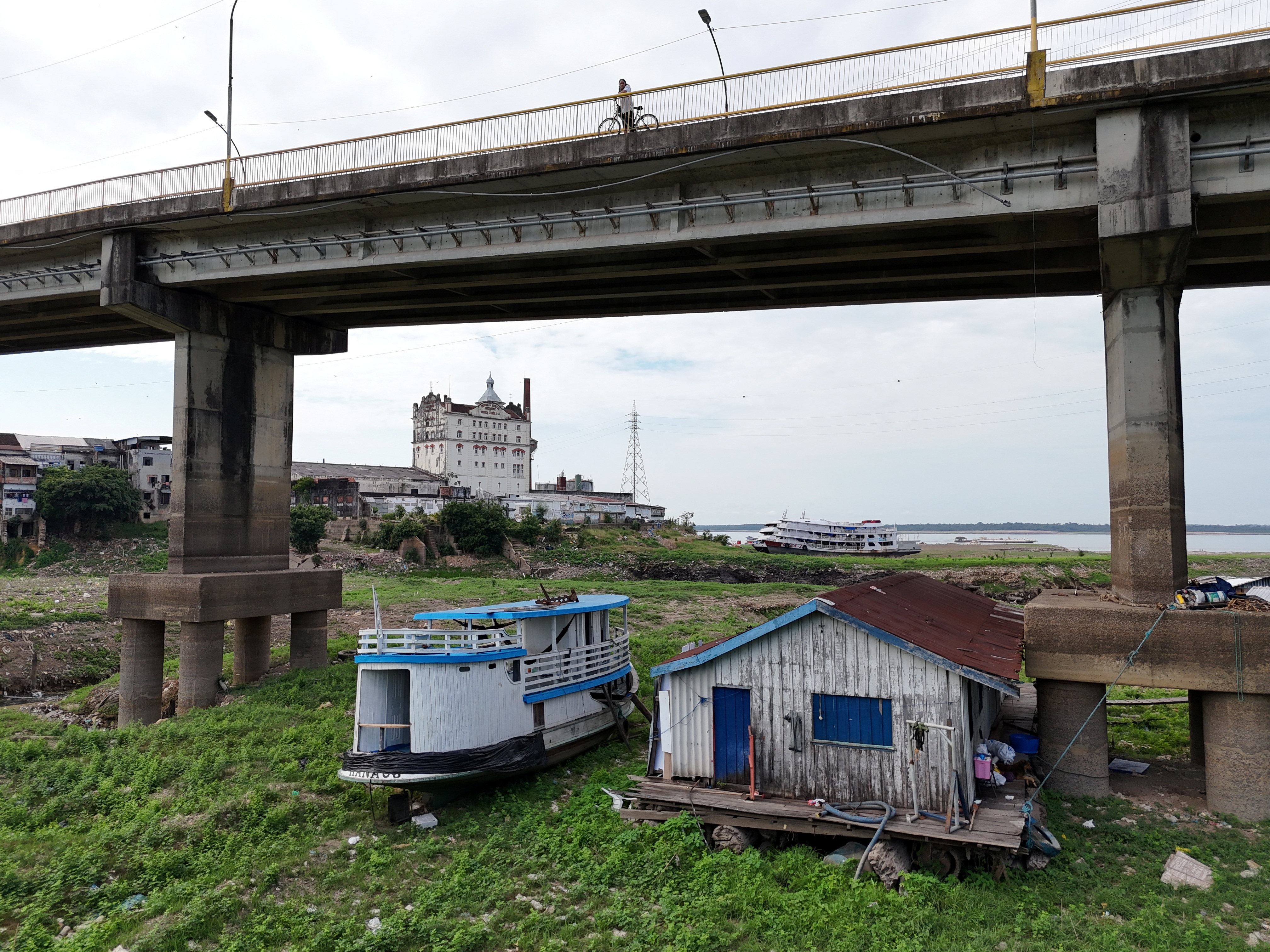 A house boat sits stranded under a bridge along the Rio Negro