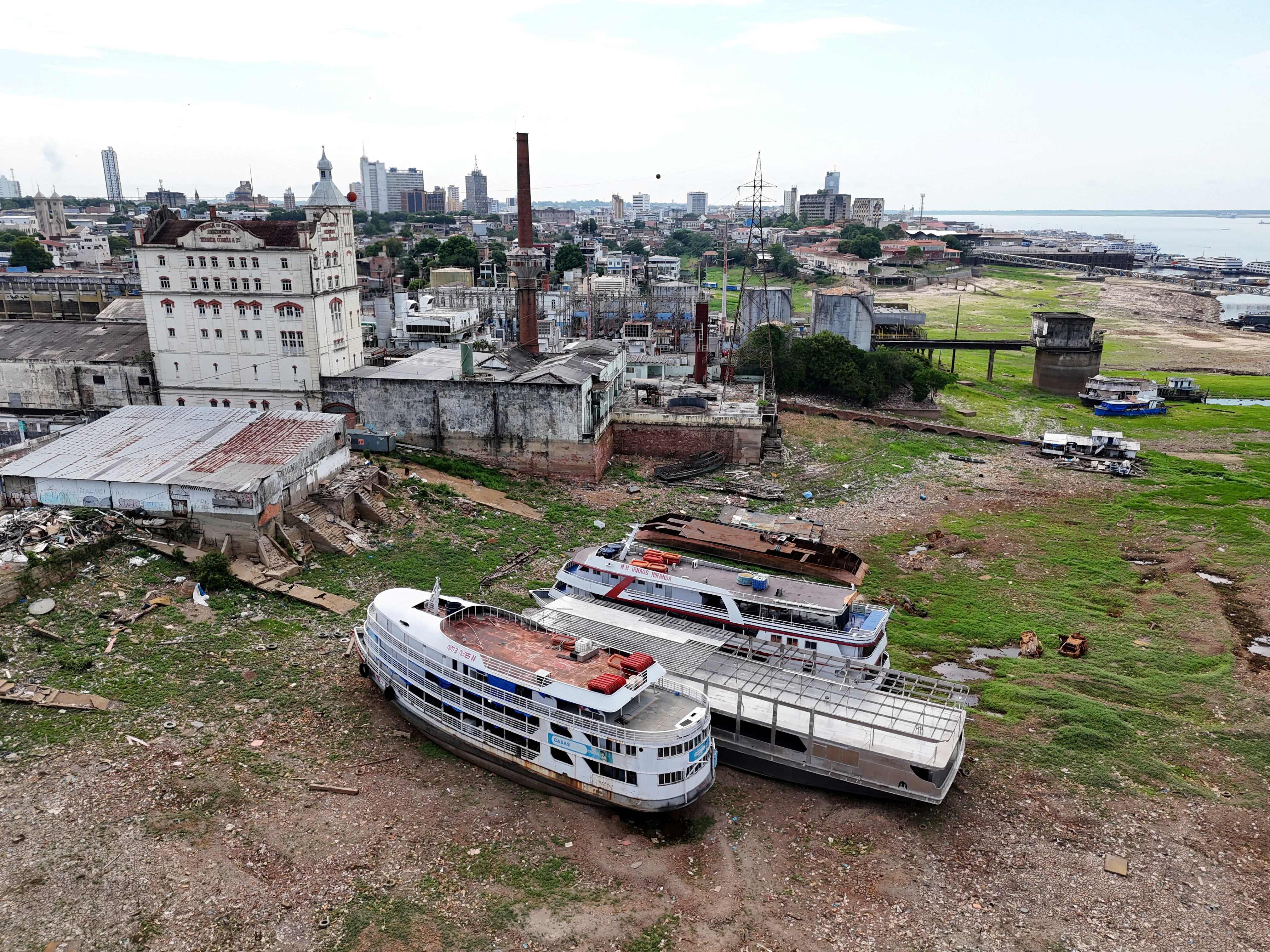 Large boats sit stranded on dry land amid a drought in the Amazon River basin.