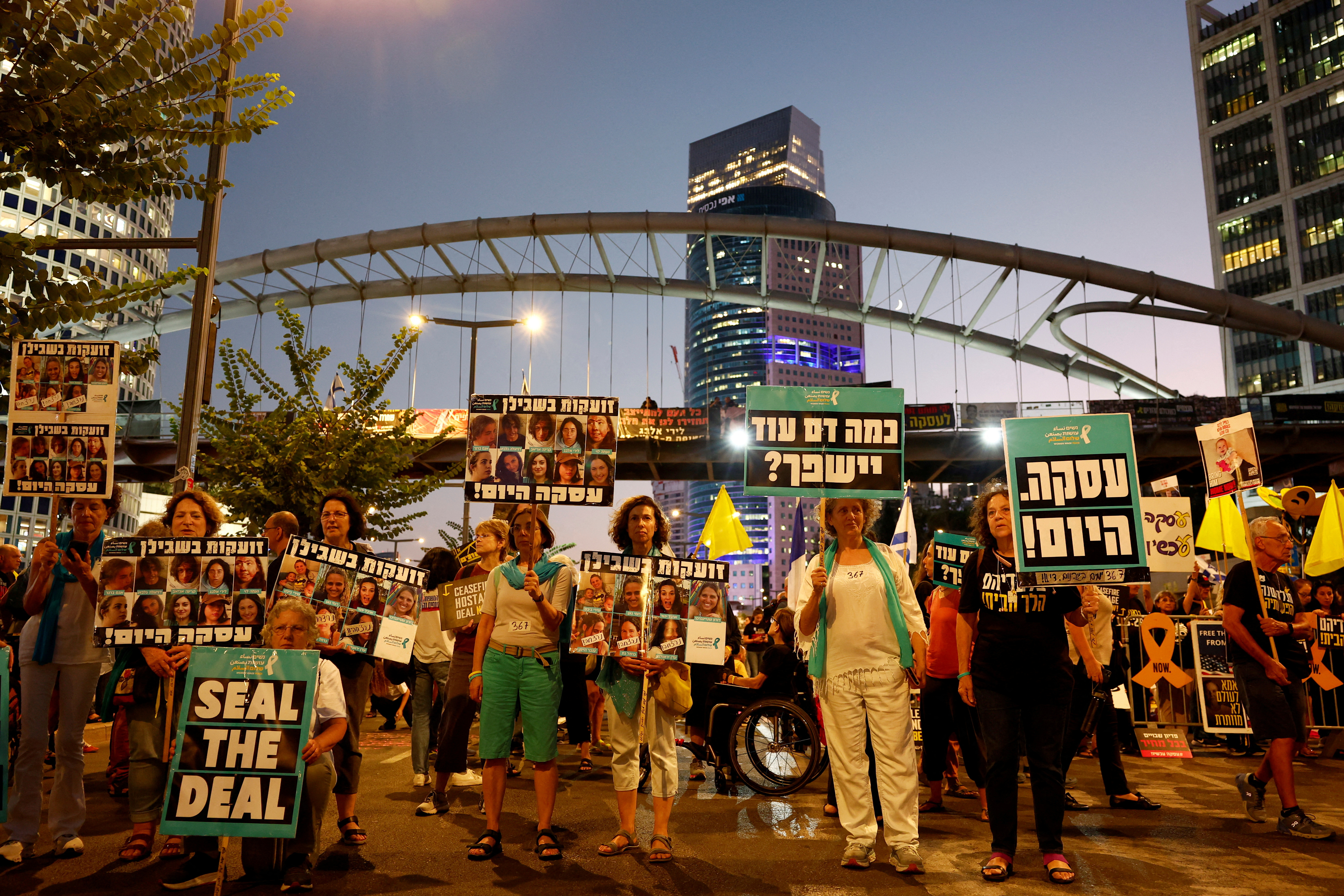 The families of hostages held in Gaza hold a silent protest to mark one year since the October 7 attack by Hamas during which their loved ones were taken captive, in Tel Aviv, Israel, October 7, 2024. [Gonzalo Fuentes/Reuters]