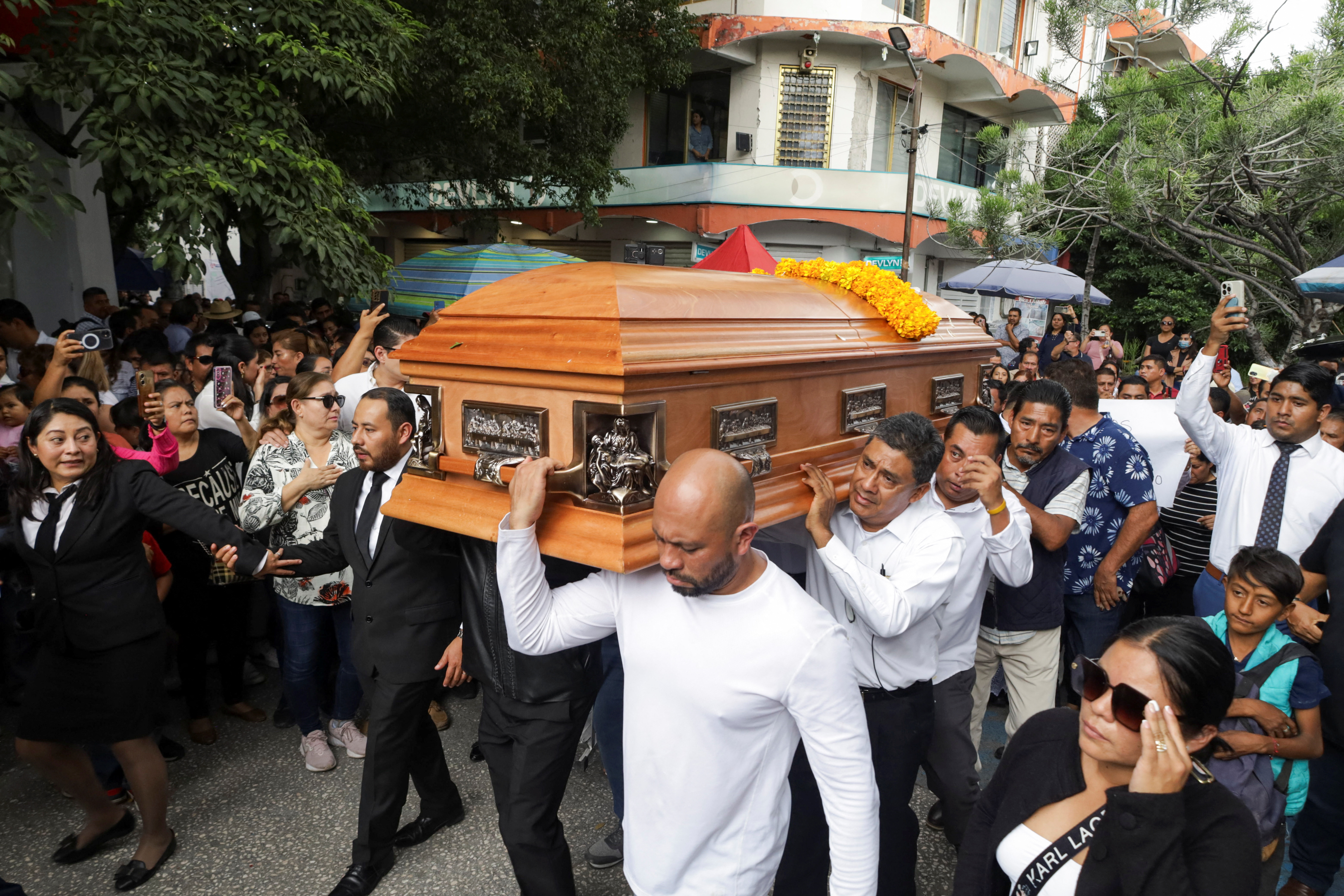 Pallbearers carry the coffin of Alejandro Arcos through the streets in Chilpancingo.