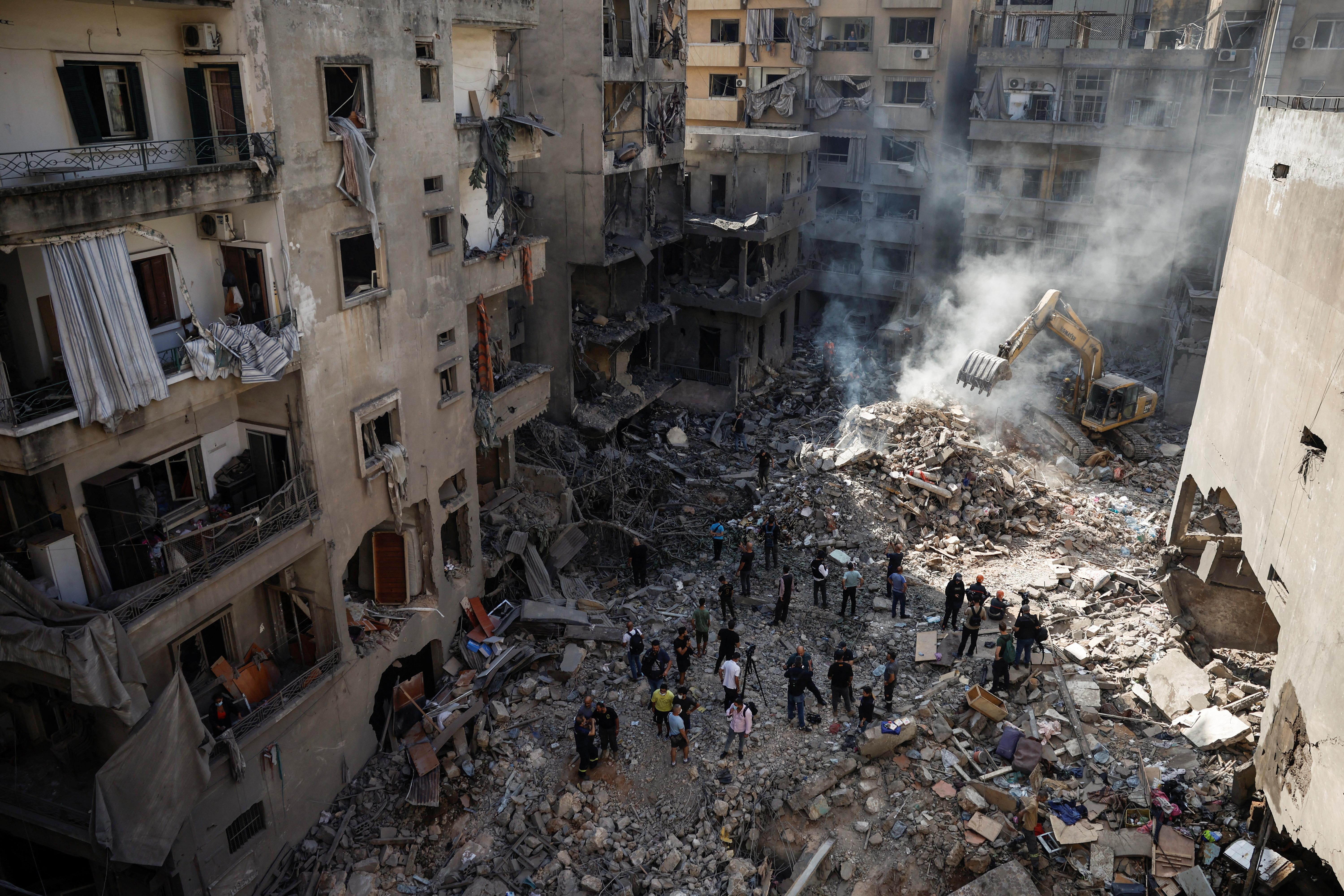 Emergency personnel work at the site of an Israeli air strike, amid ongoing hostilities between Hezbollah and Israeli forces, in Beirut, Lebanon, October 11