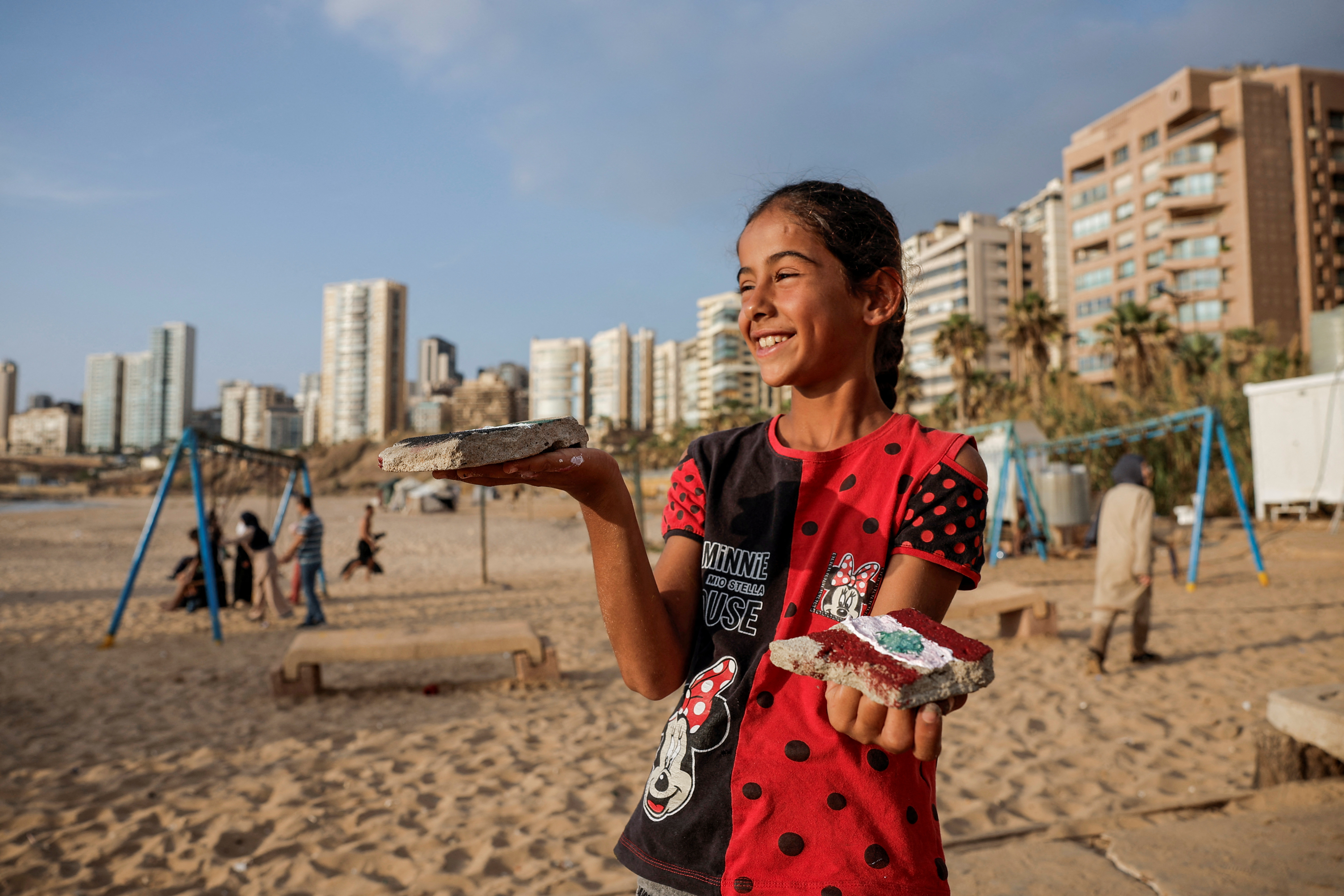 A girl holds the stones she has painted
