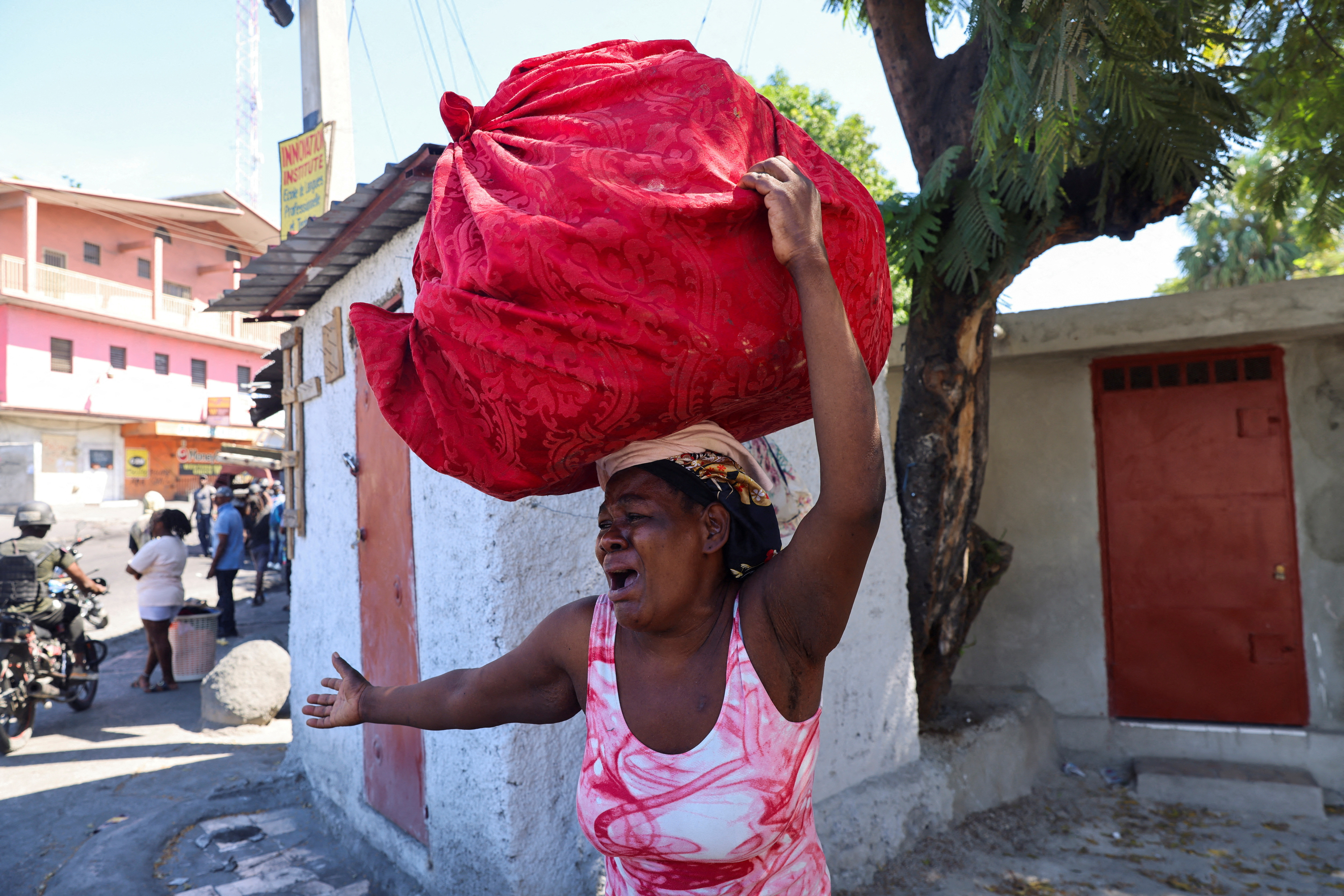 A woman reacts as she flees her home from gang violence, in Port-au-Prince, Haiti, October 26, 2024. REUTERS/Ralph Tedy Erol TPX IMAGES OF THE DAY