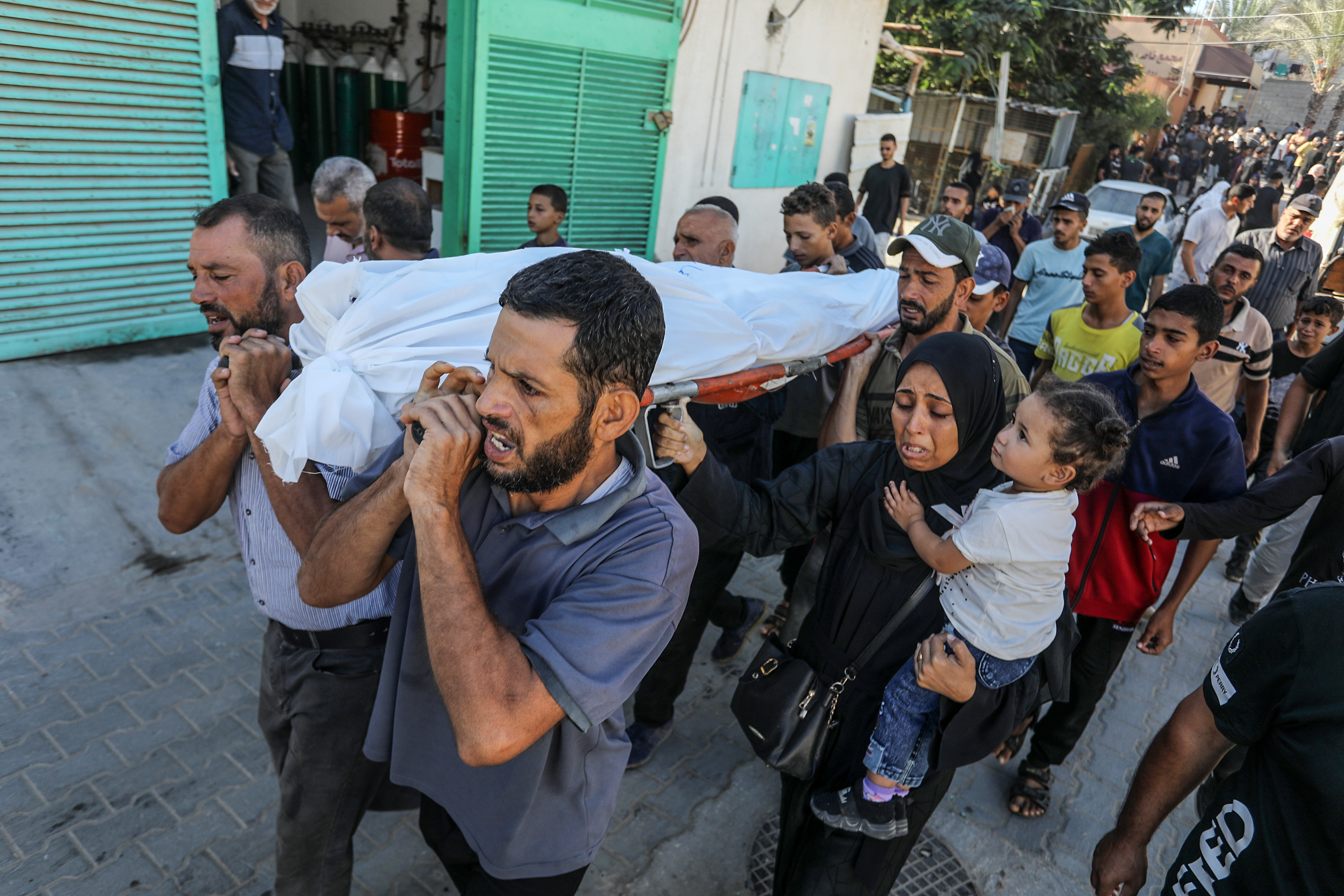 Relatives of the Palestinians who lost their lives in Israeli attacks carry the body of a beloved one as the bodies are brought to Nasser Hospital after Israeli attacks in Khan Yunis, Gaza on October 3, 2024.