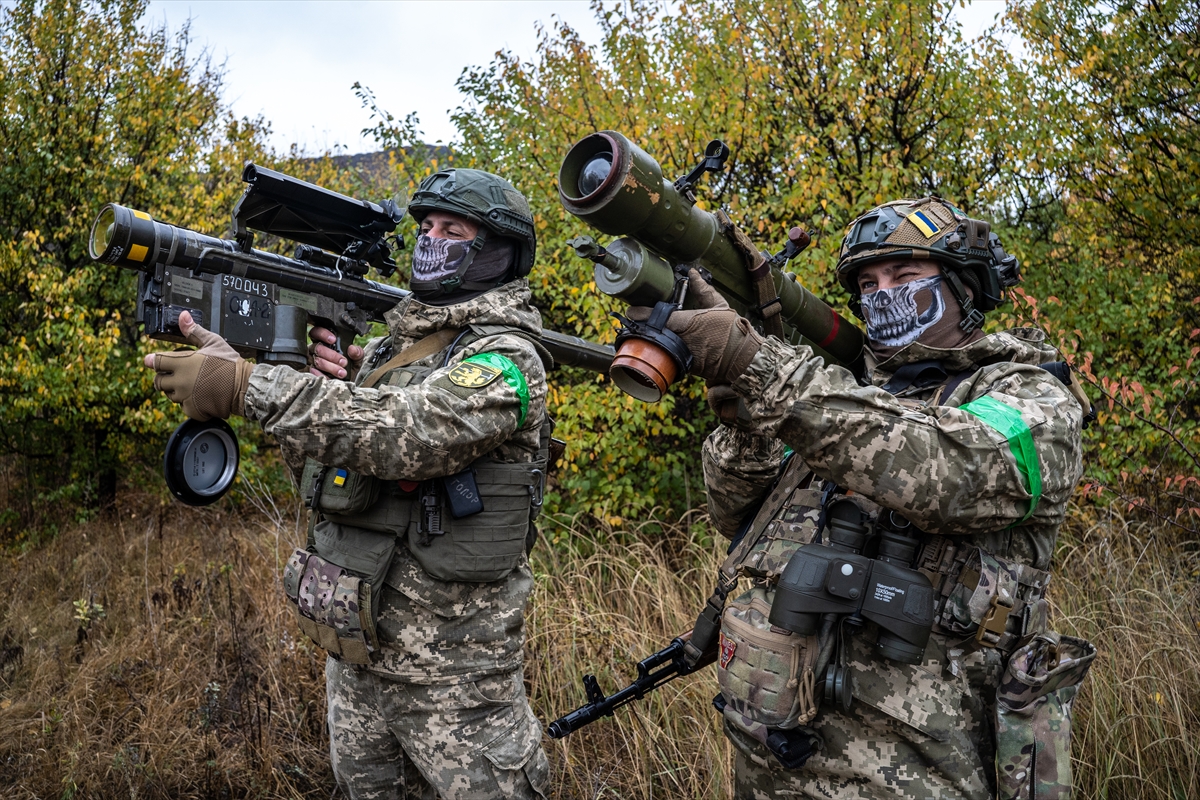 Two Ukrainian soldiers check the scopes of their anti-aircraft systems to ensure they're working properly before heading out on a mission in Donetsk Oblast, Ukraine on October 19, 2024. The Ukrainian military relies on small, mobile units to defend and protect the skies as warfare evolves, with the proliferation of drones and Russian air superiority. Photojournalist:Fermin Torrano