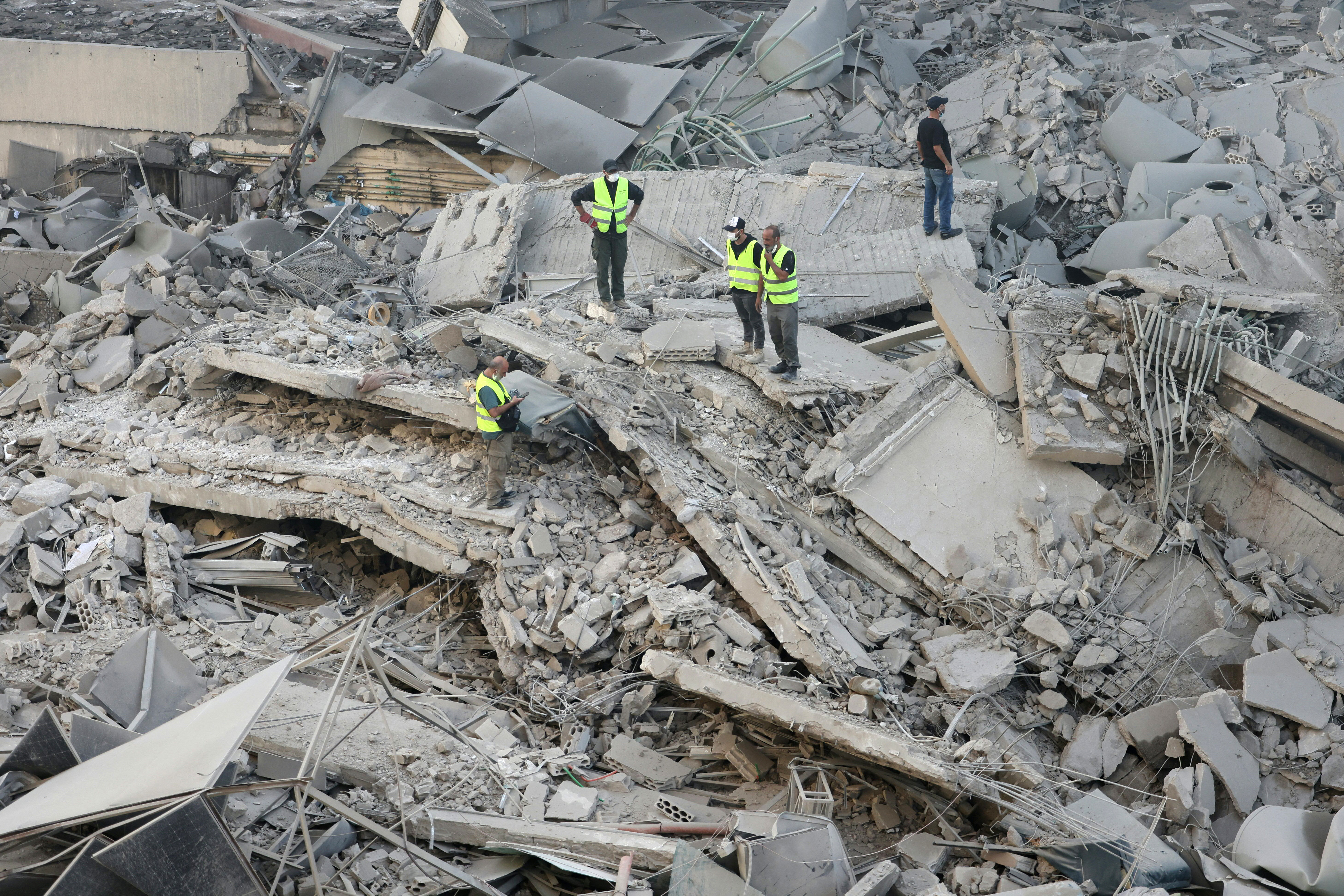 Rescuers check the site of an overnight Israeli airstrike in Beirut's southern suburb of Shayyah on October 2, 2024. - At least five Israeli strikes hit Beirut's southern suburbs early October 2