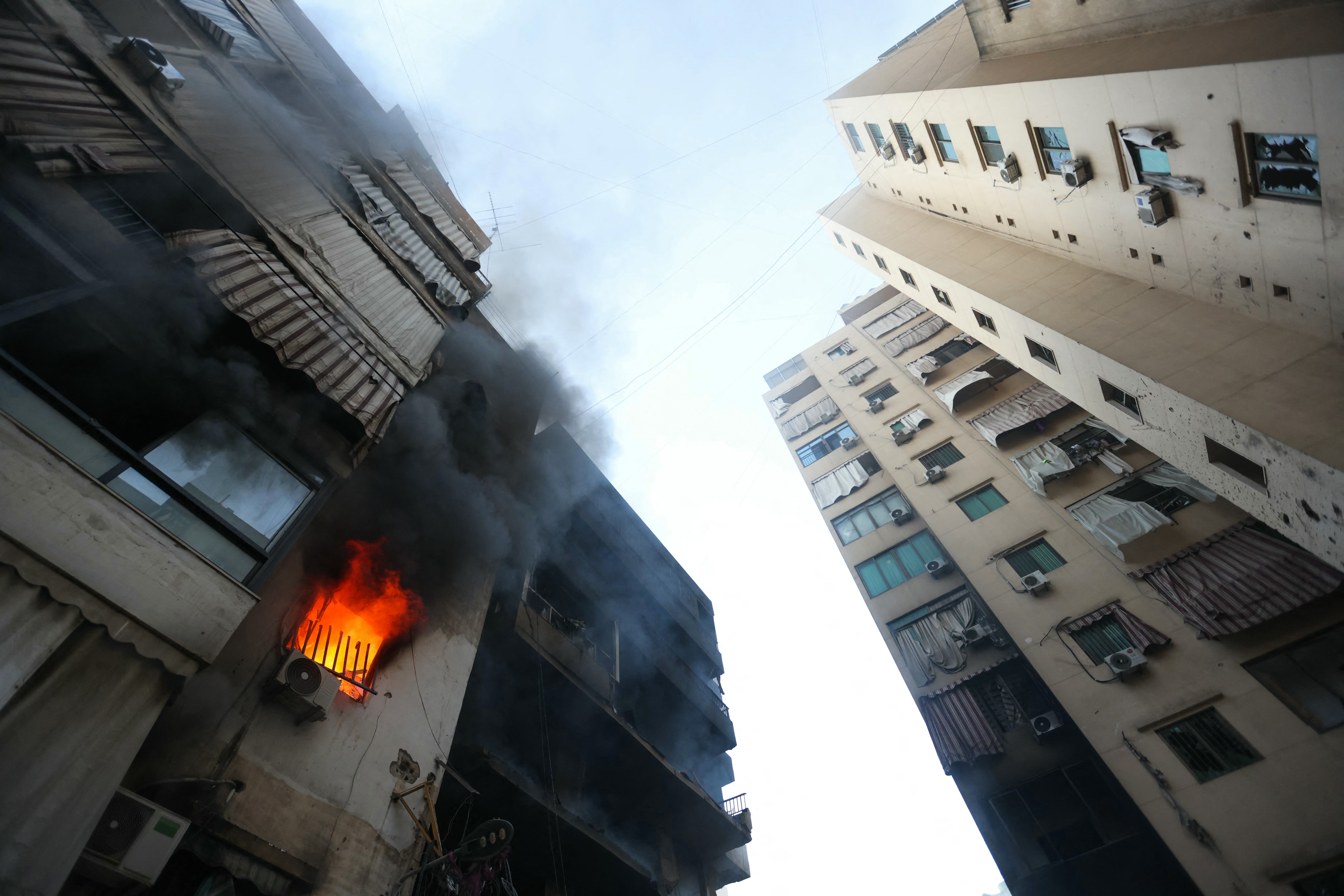 A fire burns in a damaged building at the site of overnight Israeli airstrikes on the Chiah neighbourhood in Beirut's southern suburbs on October 4