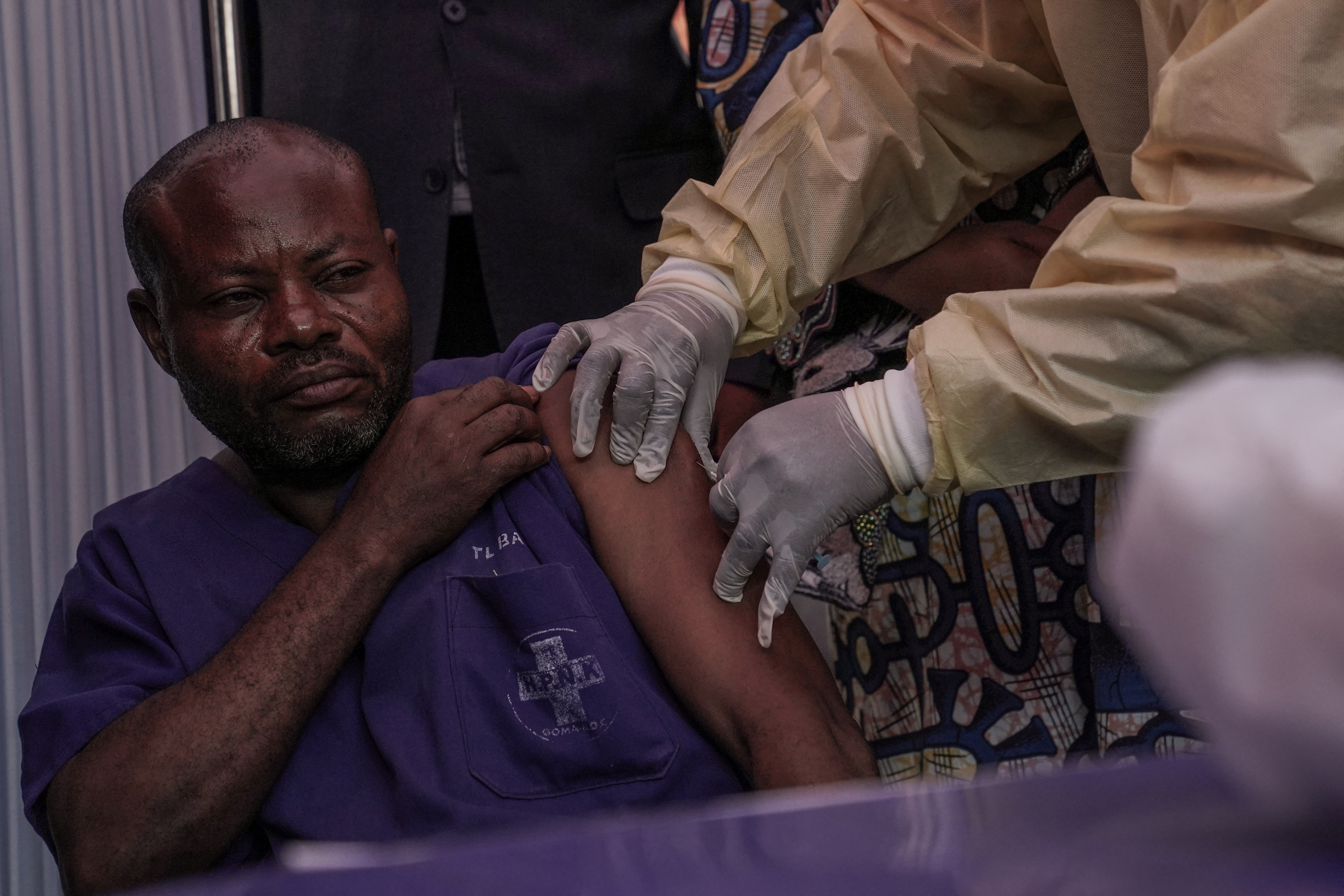 A clinician administers the mpox vaccine to a hospital staff member during the launch of the vaccination campaign at the General Hospital of Goma