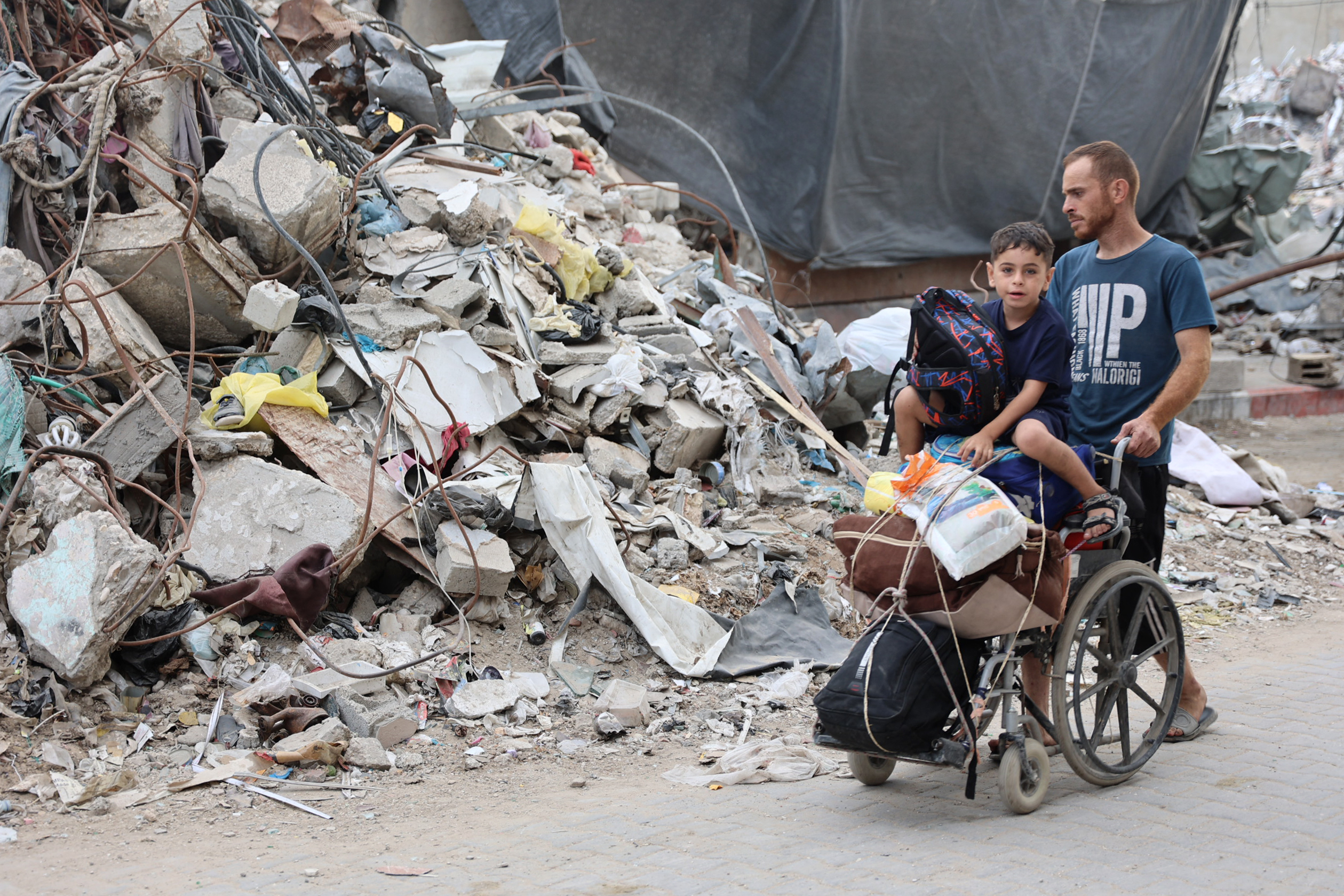 A Palestinian family arrives in Gaza City after evacuating their homes in the Jabalia area on October 6, 2024