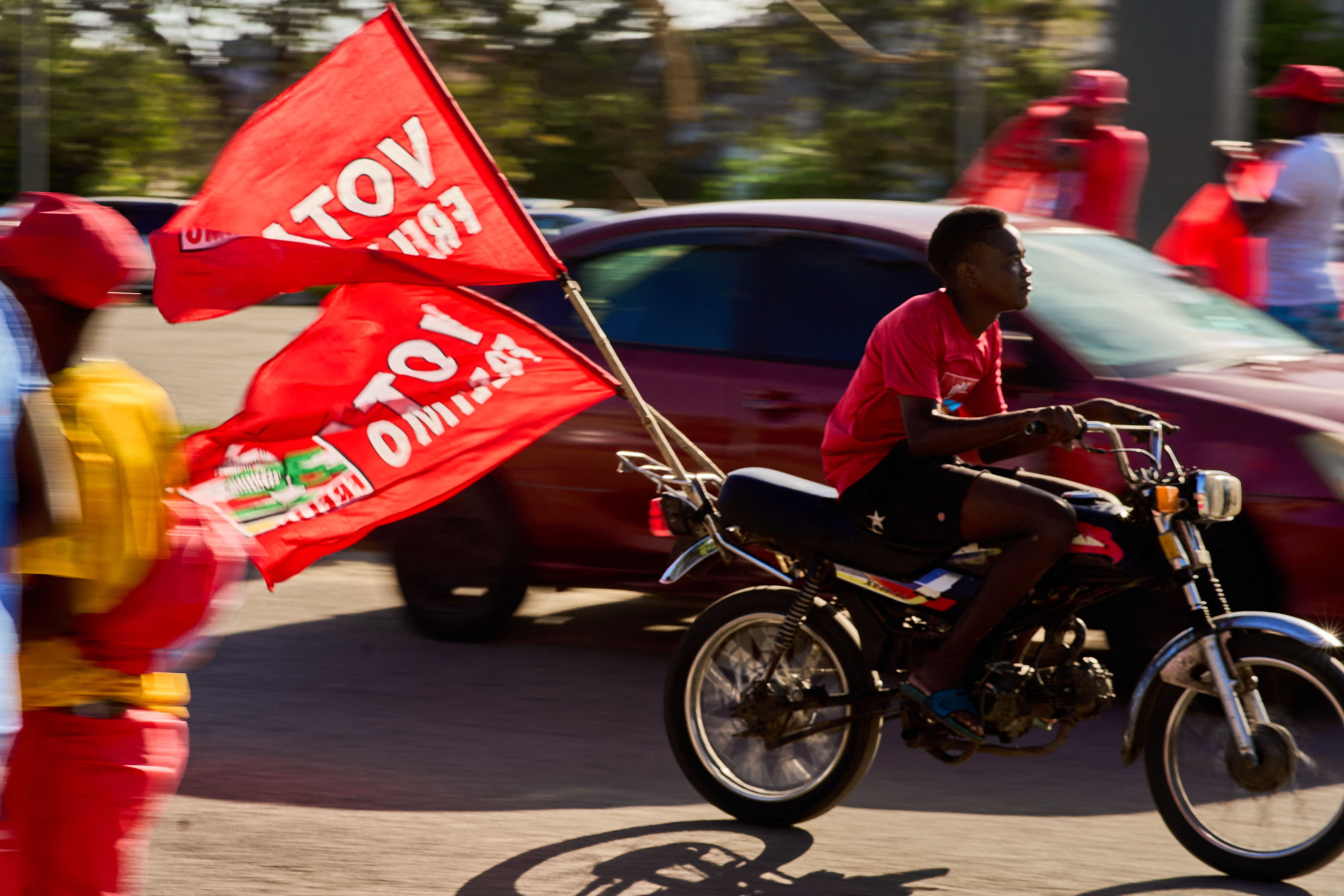 A motorcyclist with flags of the Mozambique Liberation Front (Frelimo) party