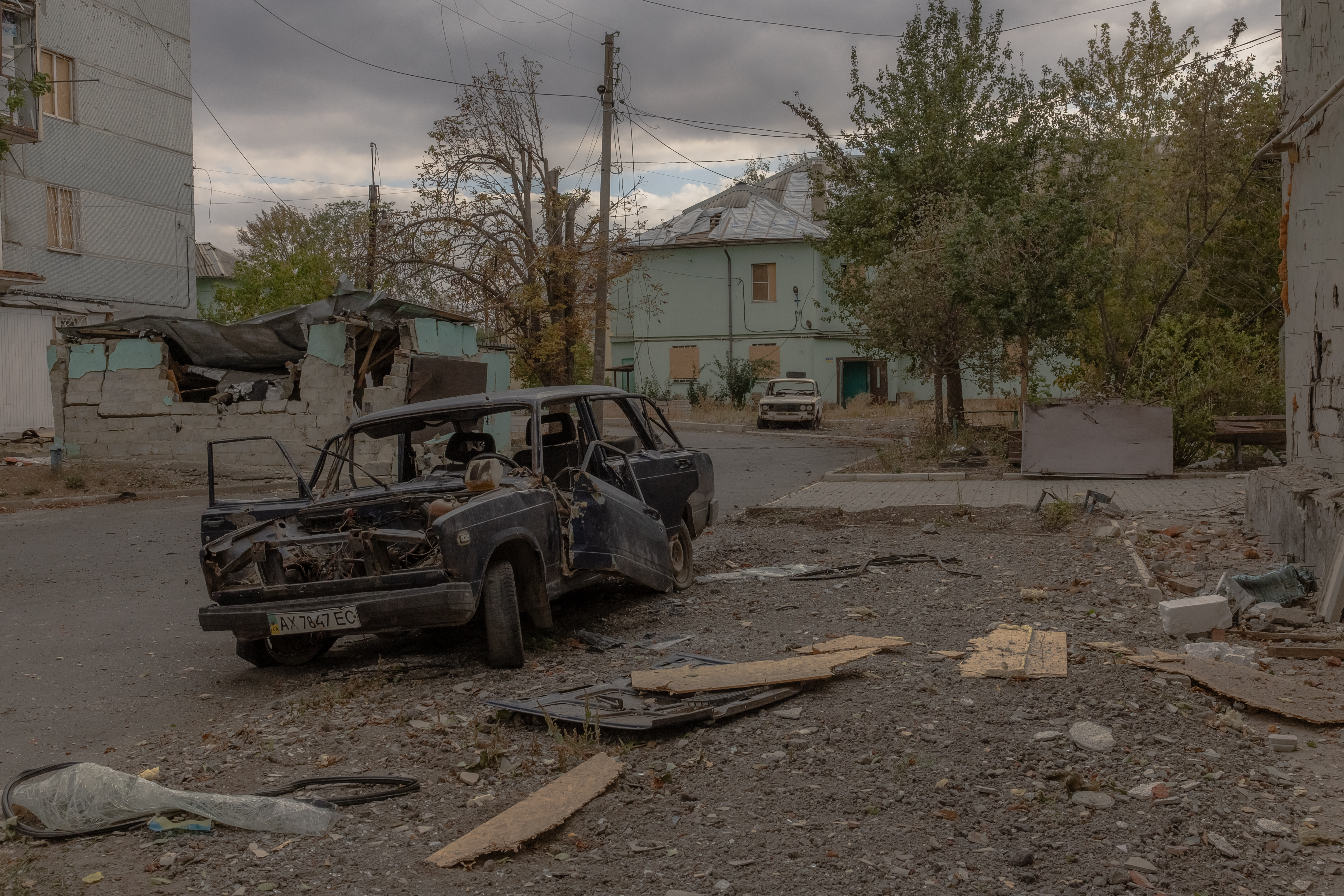 Bombed out cars and damaged buildings on the streets near the front line in eastern Ukraine.