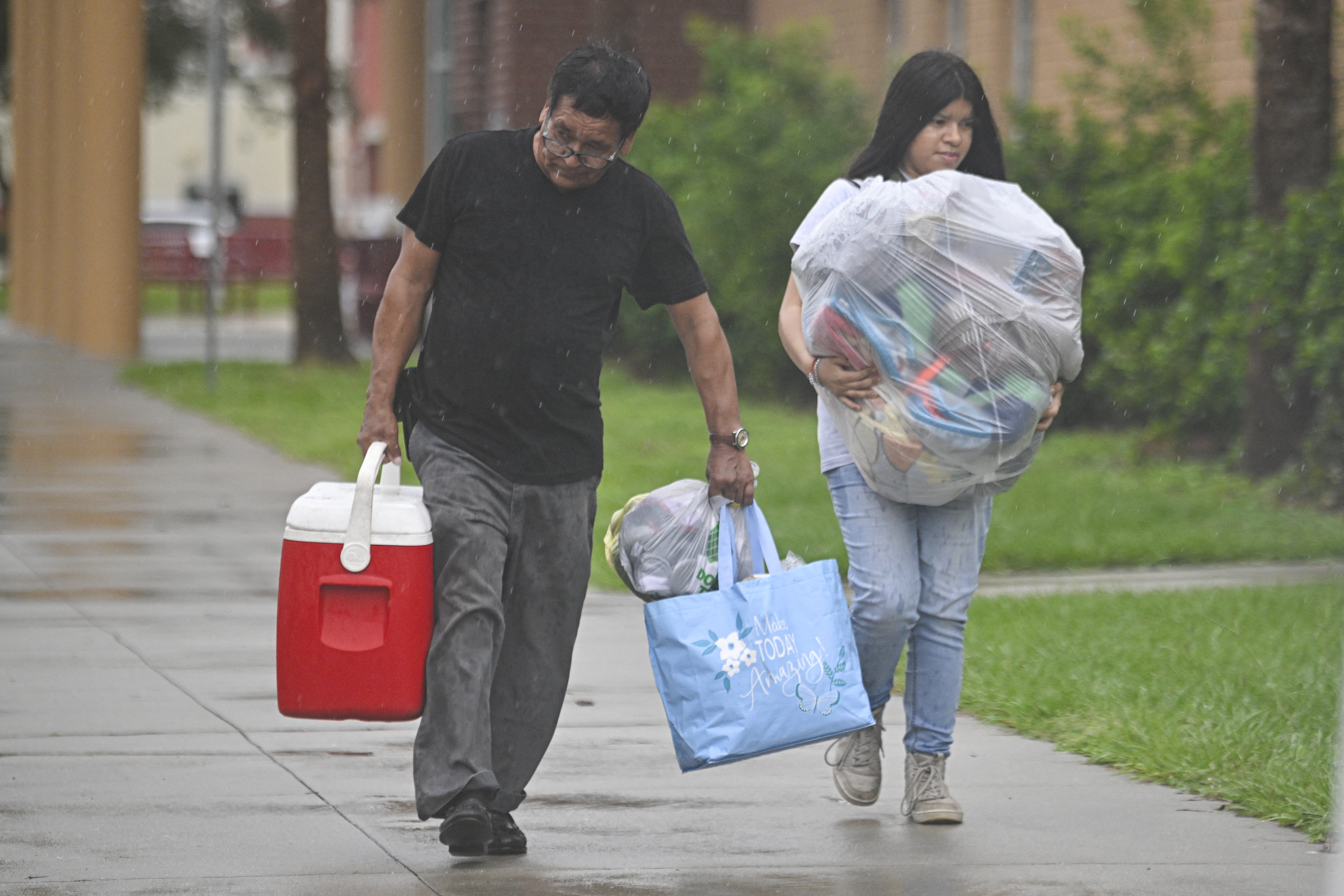 People arrive to shelter buffalo creek middle school ahead of Hurricane Milton expected landfall in Bradenton, Florida on October 9