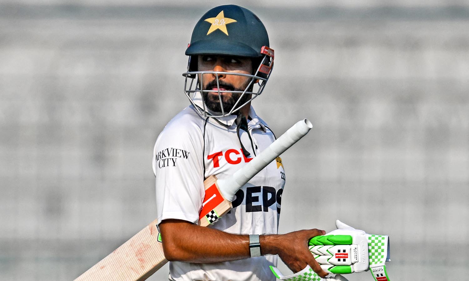 Pakistan's Babar Azam walks back to the pavilion after his dismissal during the fourth day of the first Test cricket match between Pakistan and England at the Multan Cricket Stadium in Multan on October 10, 2024. (Photo by Aamir QURESHI / AFP)