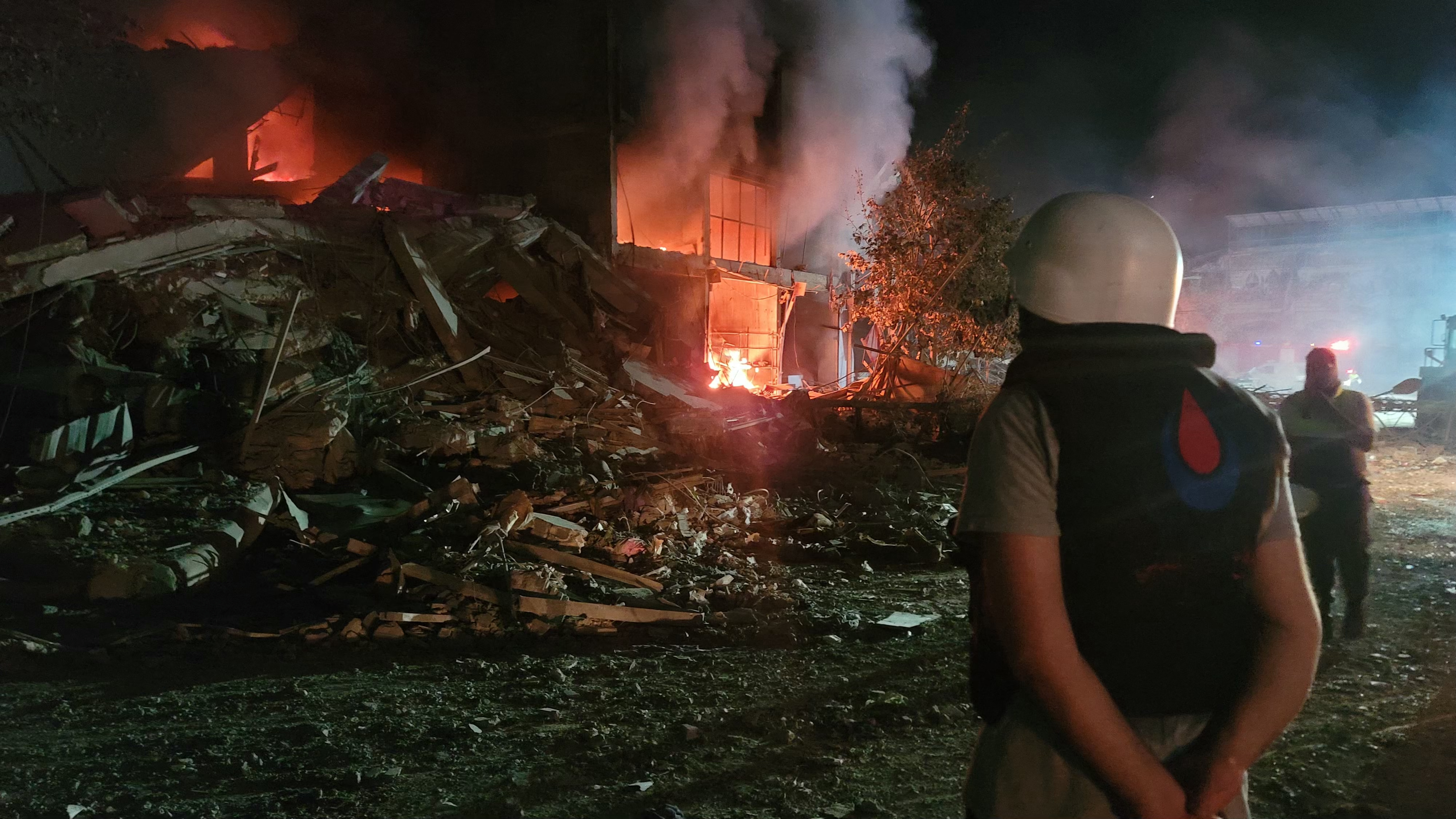 A person stands by damages at the site of an Israeli raid on the southern Lebanese city of Nabatiyeh on October 12, 2024.