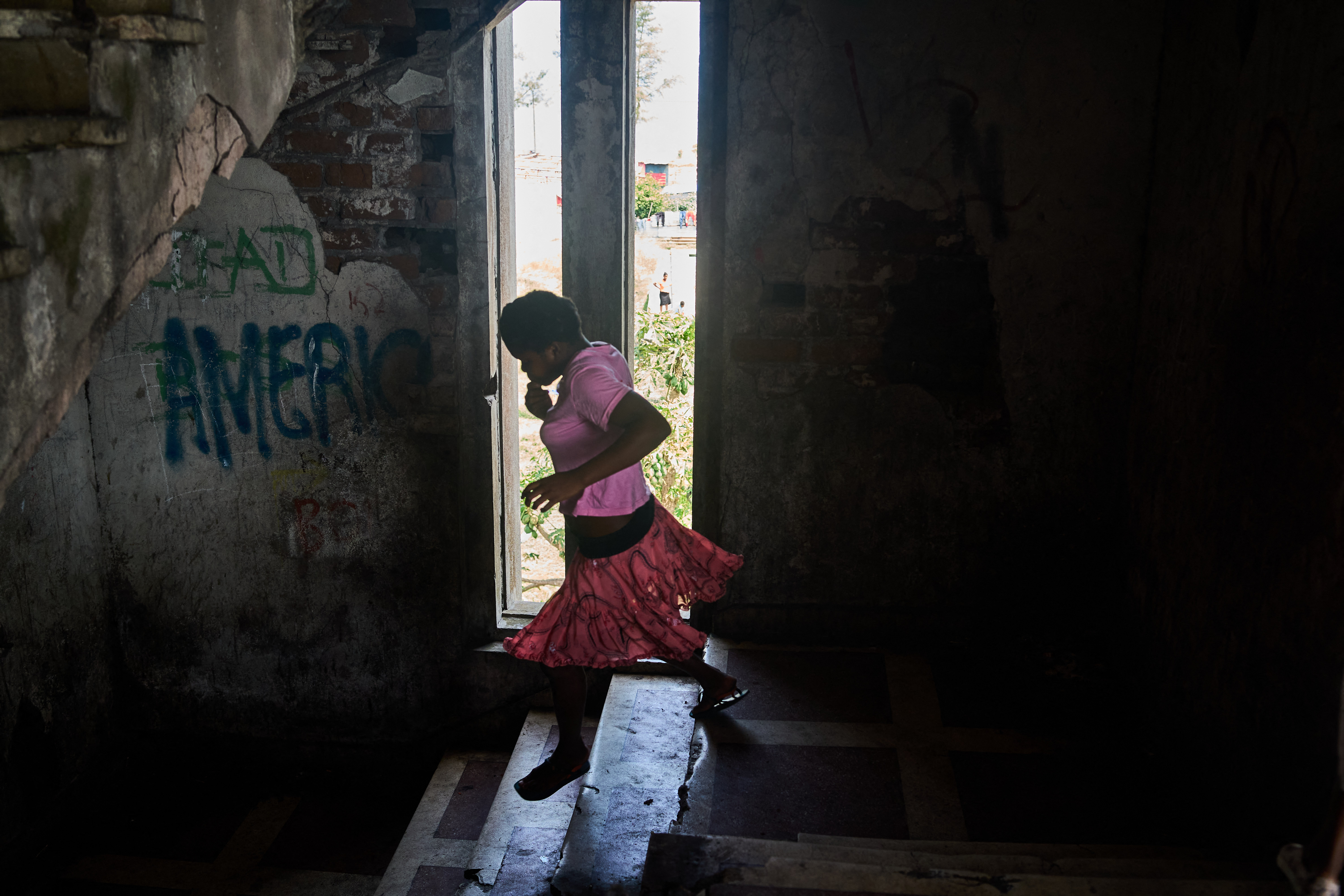 A resident walks down the stairway the Grande Hotel in Beira on October 12