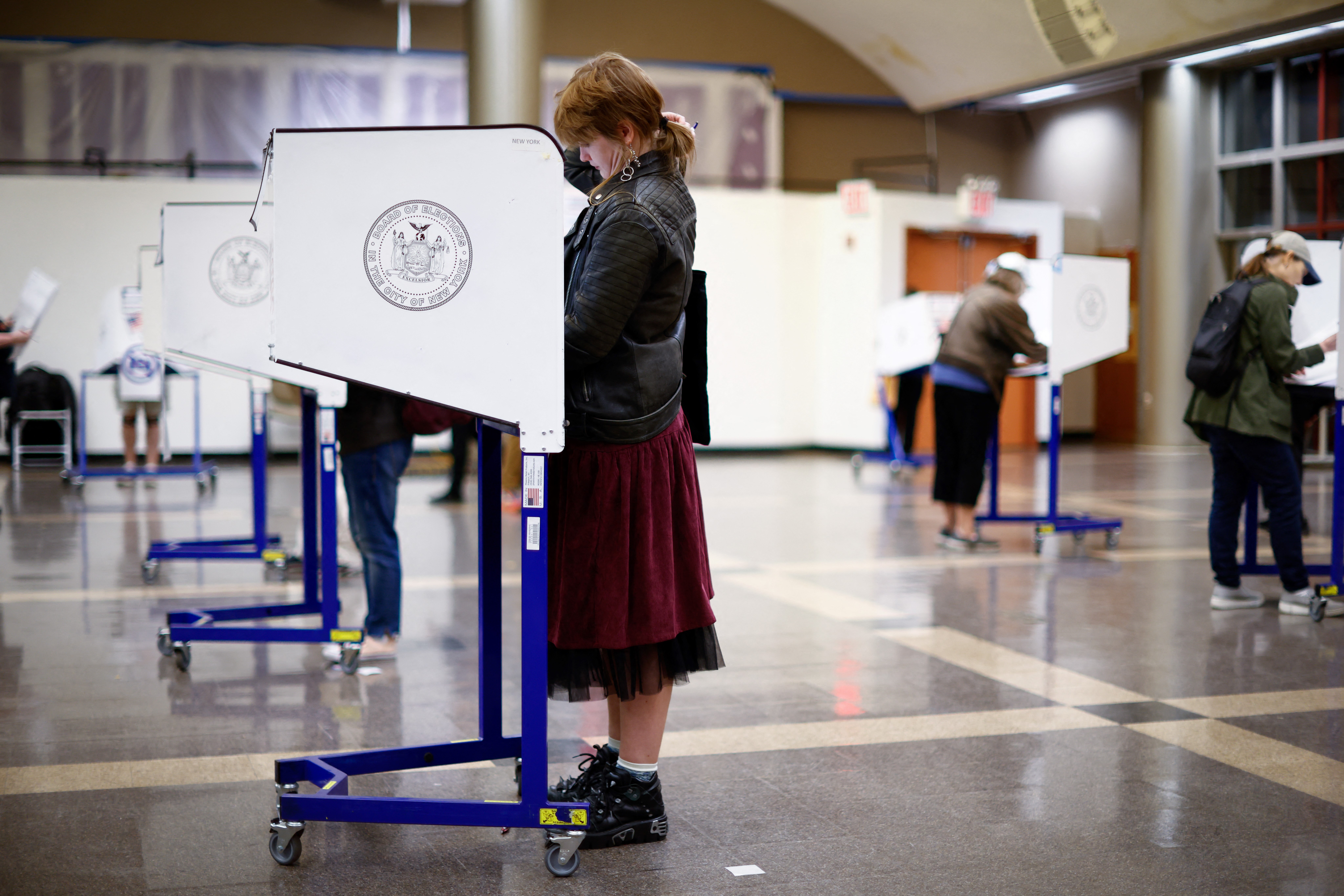 A voter fills out her ballot during first day of early voting in New York