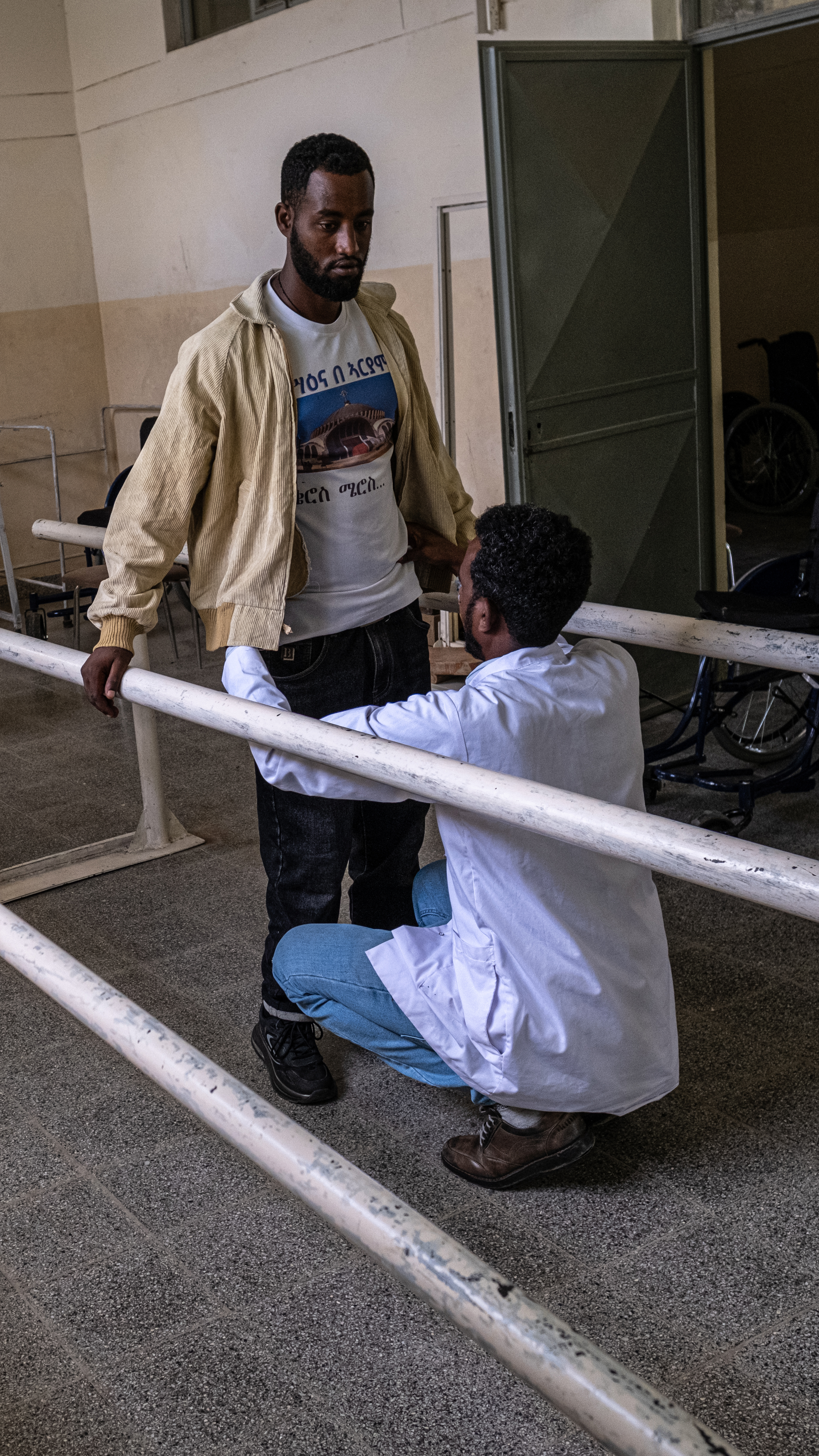 Physiotherapist Gebremedhin Haile works with Asmelash at the MOPC [Marco Simoncelli/Al Jazeera]