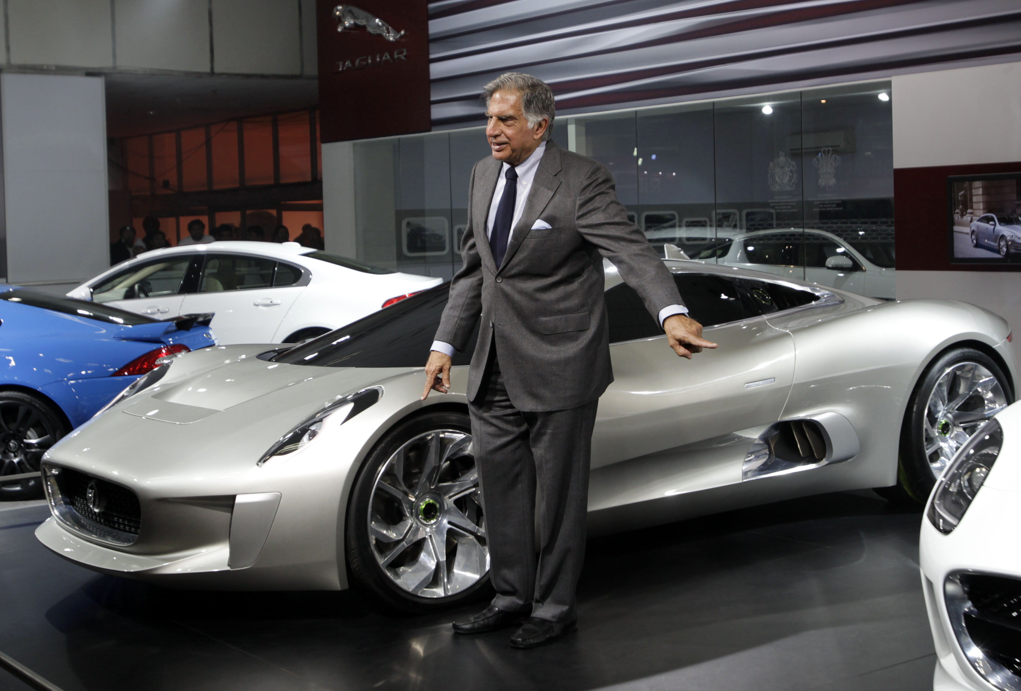 Tata Sons chairman Ratan Tata poses in front of a Jaguar C-X75 Hybrid Supercar 