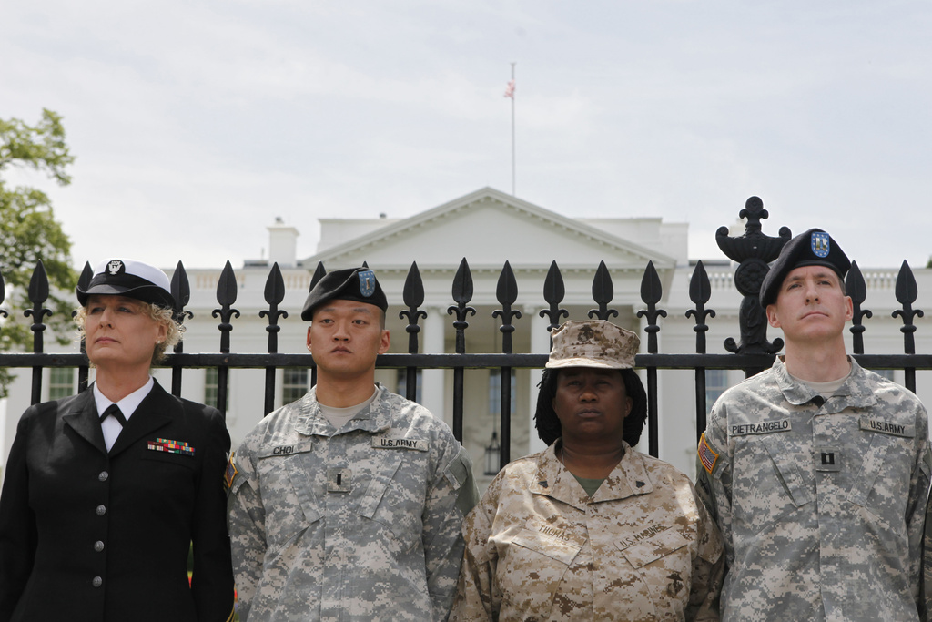 Soldiers stand outside the White House in a protest