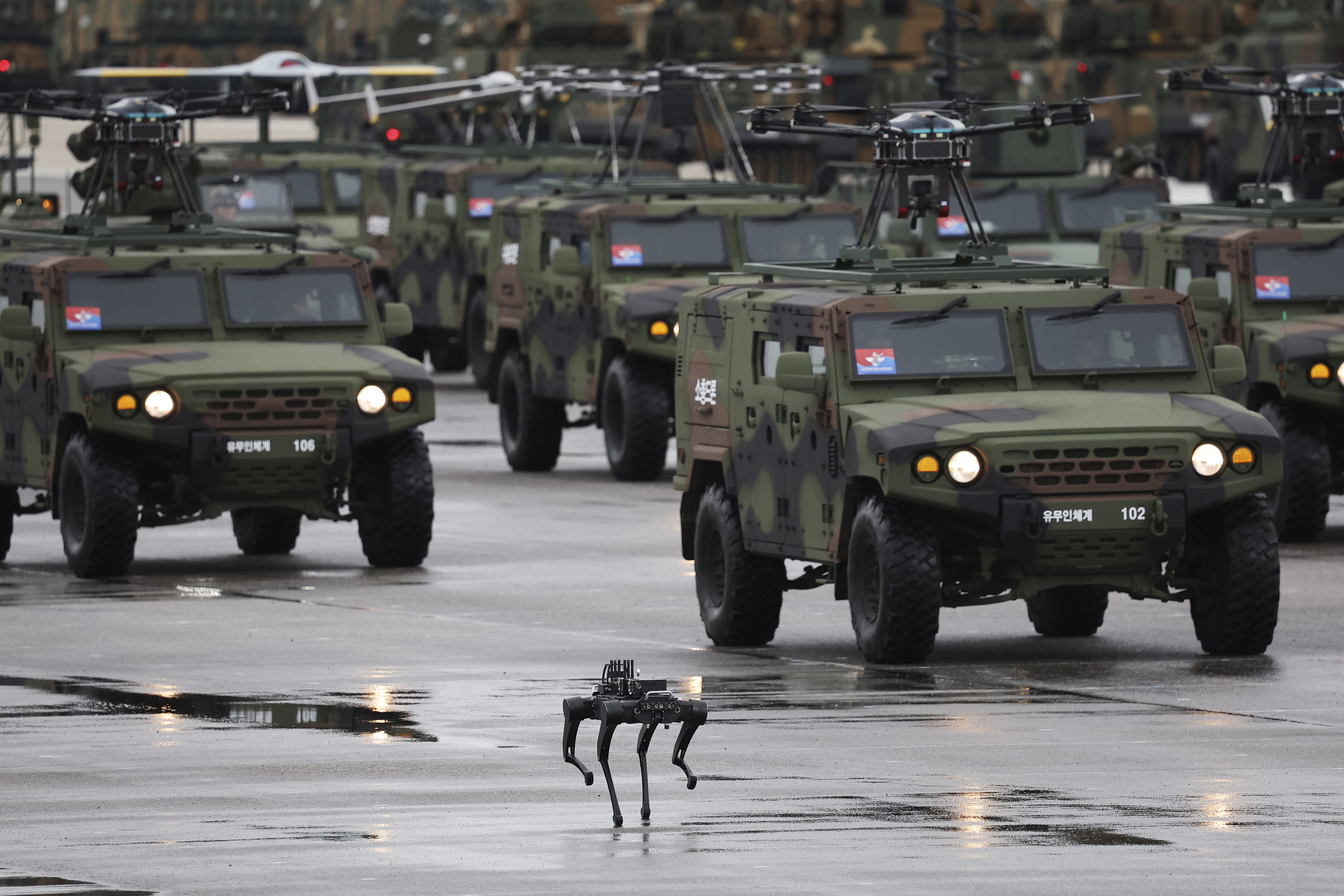 A quadruped robot in front of several military vehicles in the Seongnam parade