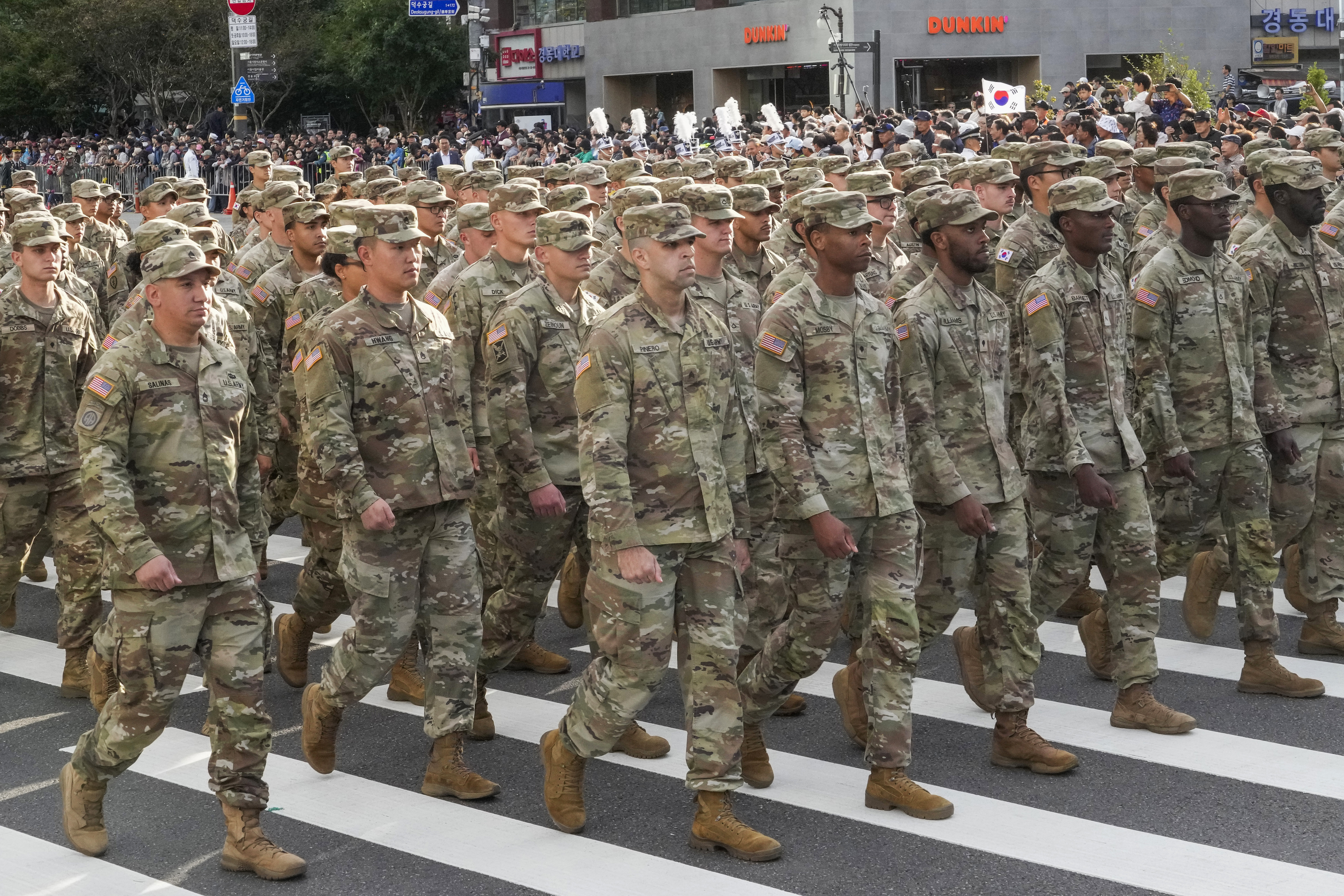 US army soldiers in the parade. They are wearing fatigues
