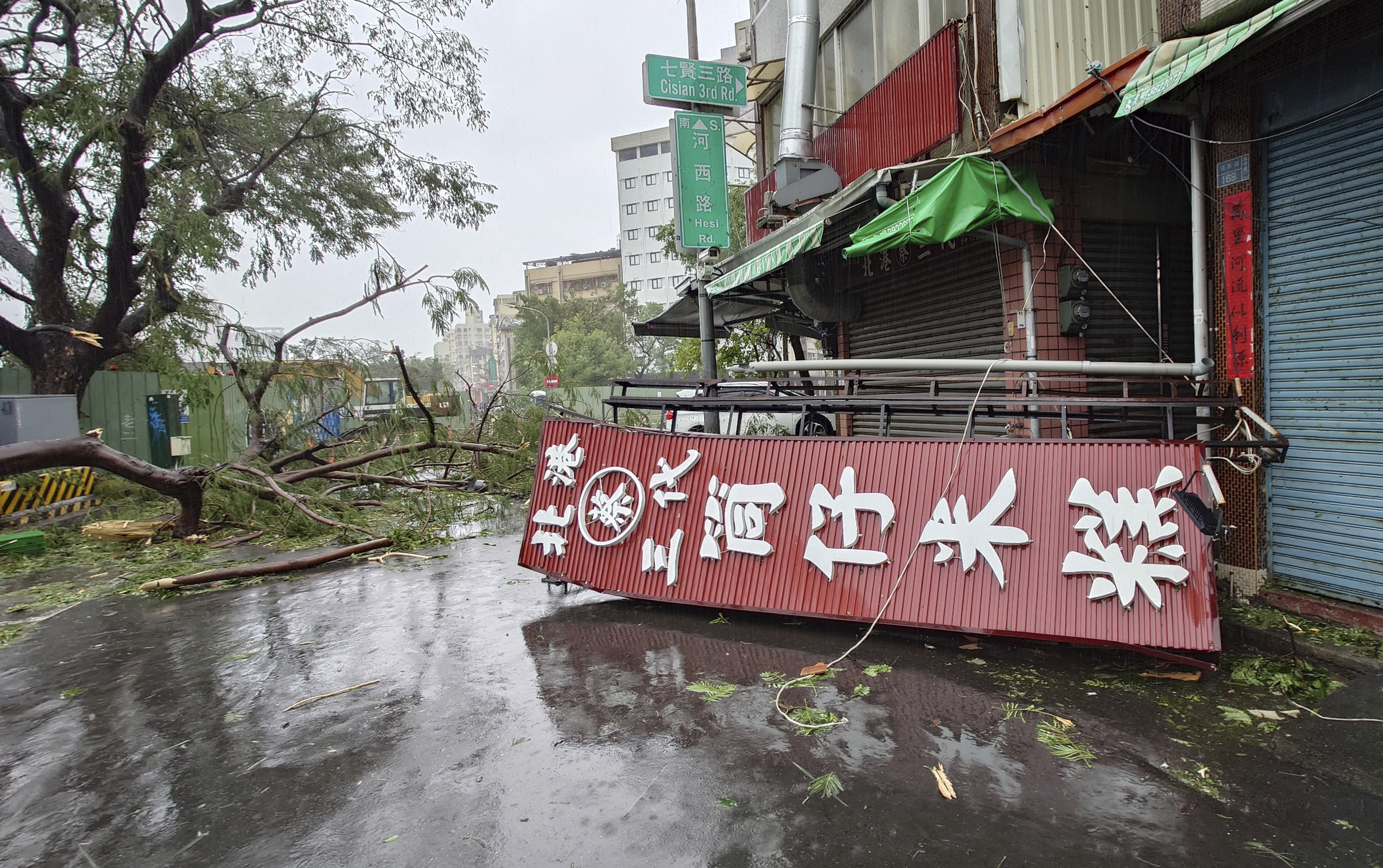 A fallen signage lies on the pavement as as Typhoon Krathon makes landfall in Kaohsiung, southern Taiwan, Thursday, Oct. 3