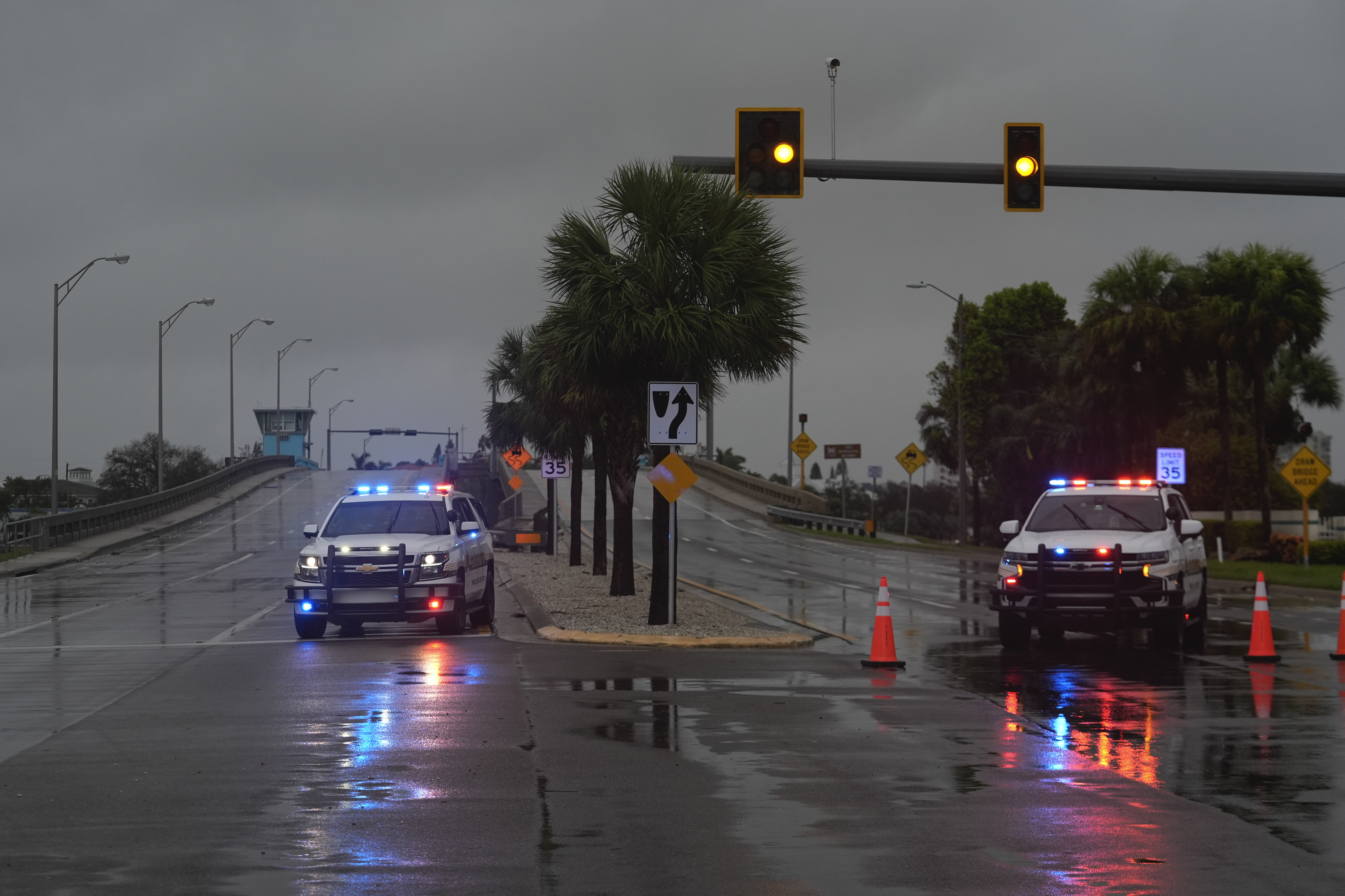Police block off a bridge leading to the barrier island of St. Pete Beach, Fla., ahead of the arrival of Hurricane Milton, in South Pasadena, Fla., Wednesday, Oct. 9