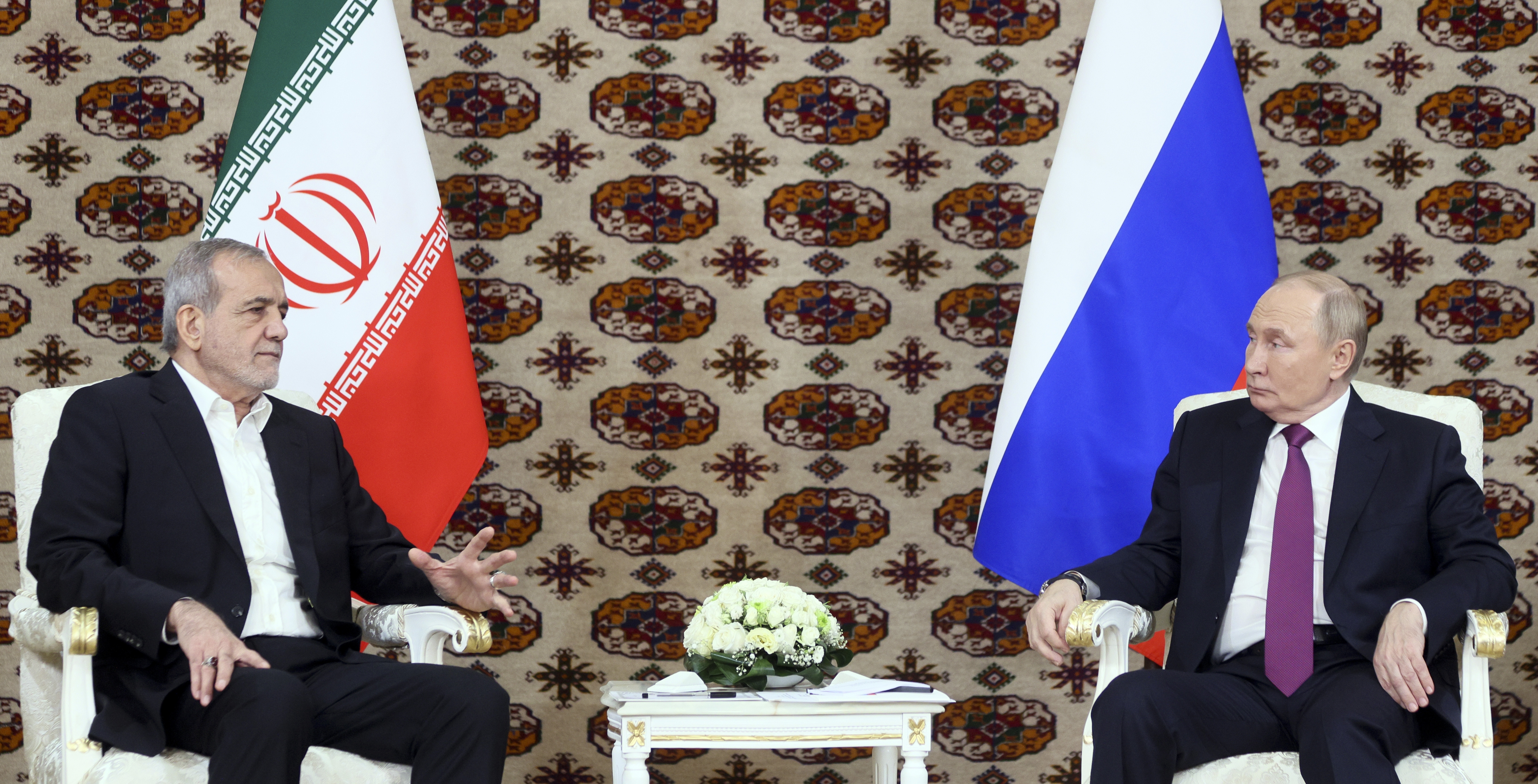 Russian President Vladimir Putin, right, listens to Iranian President Masoud Pezeshkian