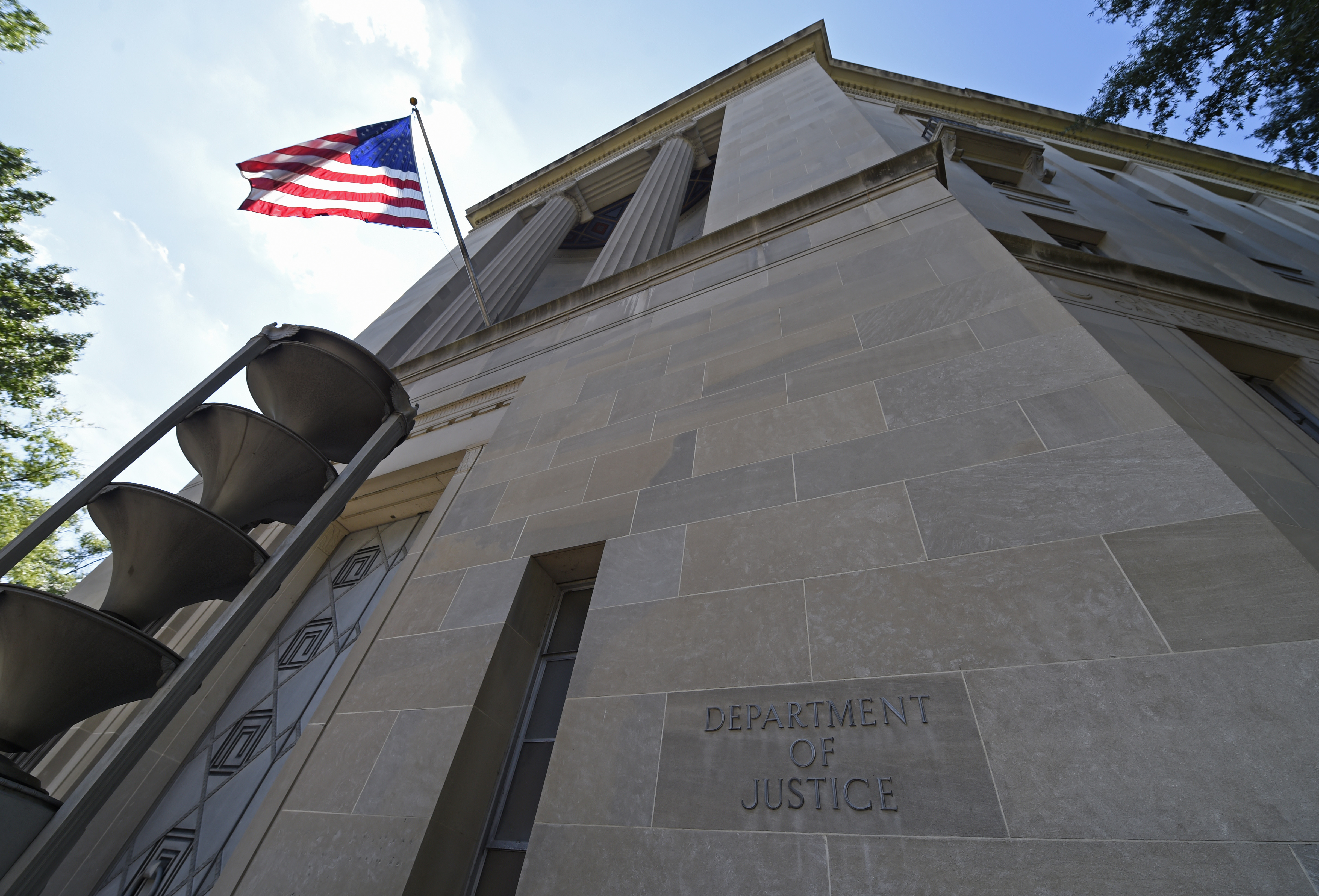 The view of the Justice Department in Washington, Thursday, Aug. 27, 2015. The Associated Press sued the U.S. Department of Justice Thursday over the FBI's failure to provide public records related to the creation of a fake news story used to plant surveillance software on a suspect's computer. (AP Photo/Susan Walsh)