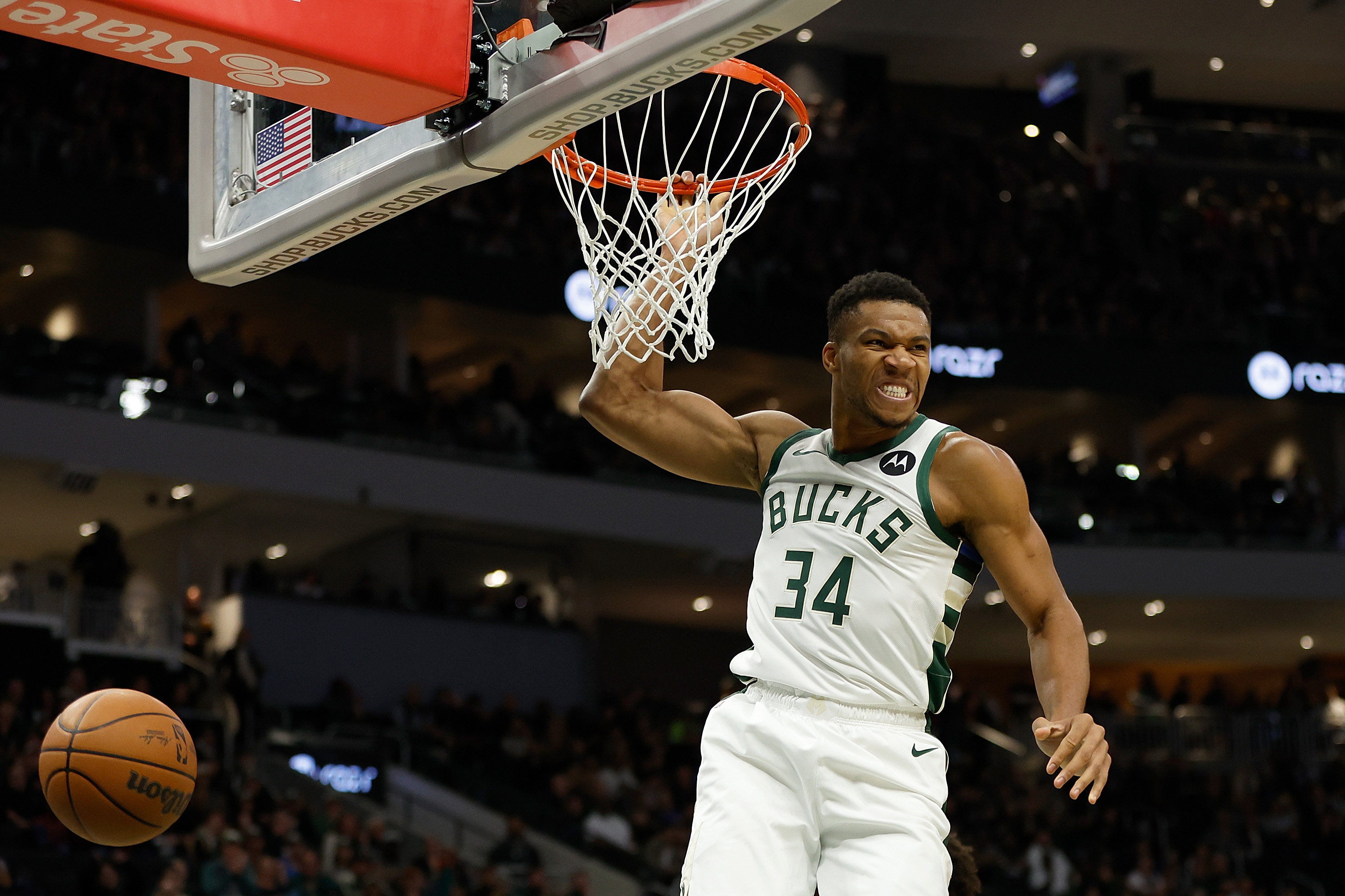 Basketball player dunks ball.