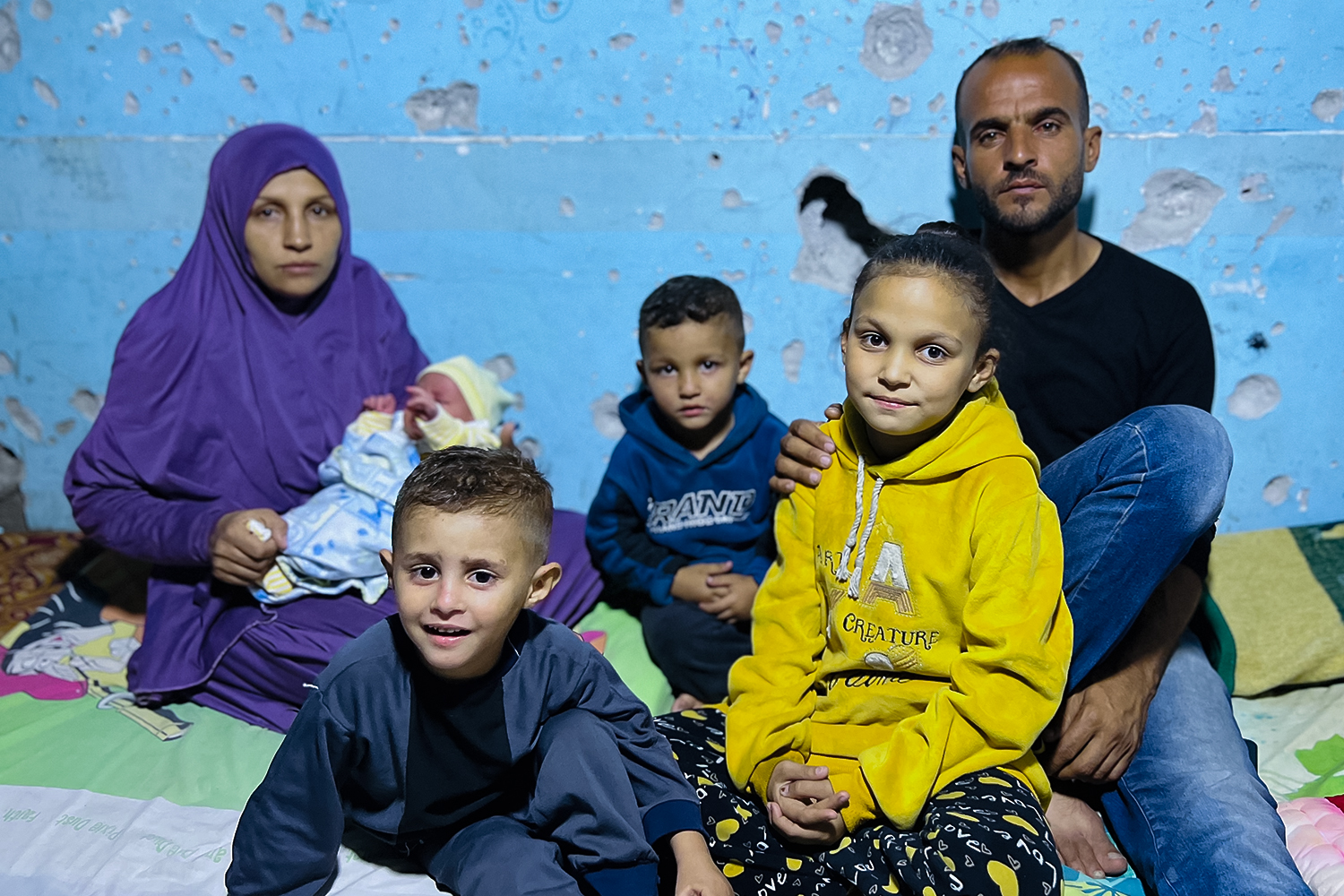 Amal, left, holding baby Sumoud, with Yousef on the right and their three other children between them